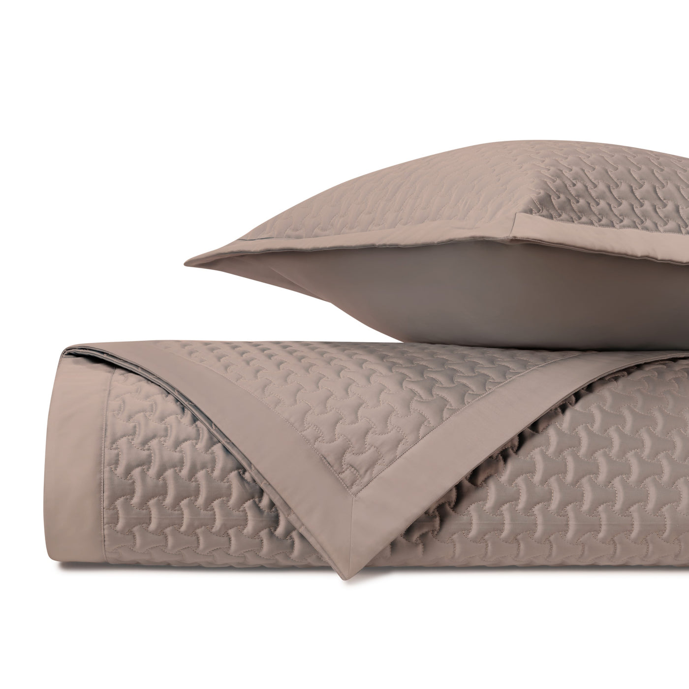 Houndstooth quilted texture detail in taupe on folded coverlet and sham.