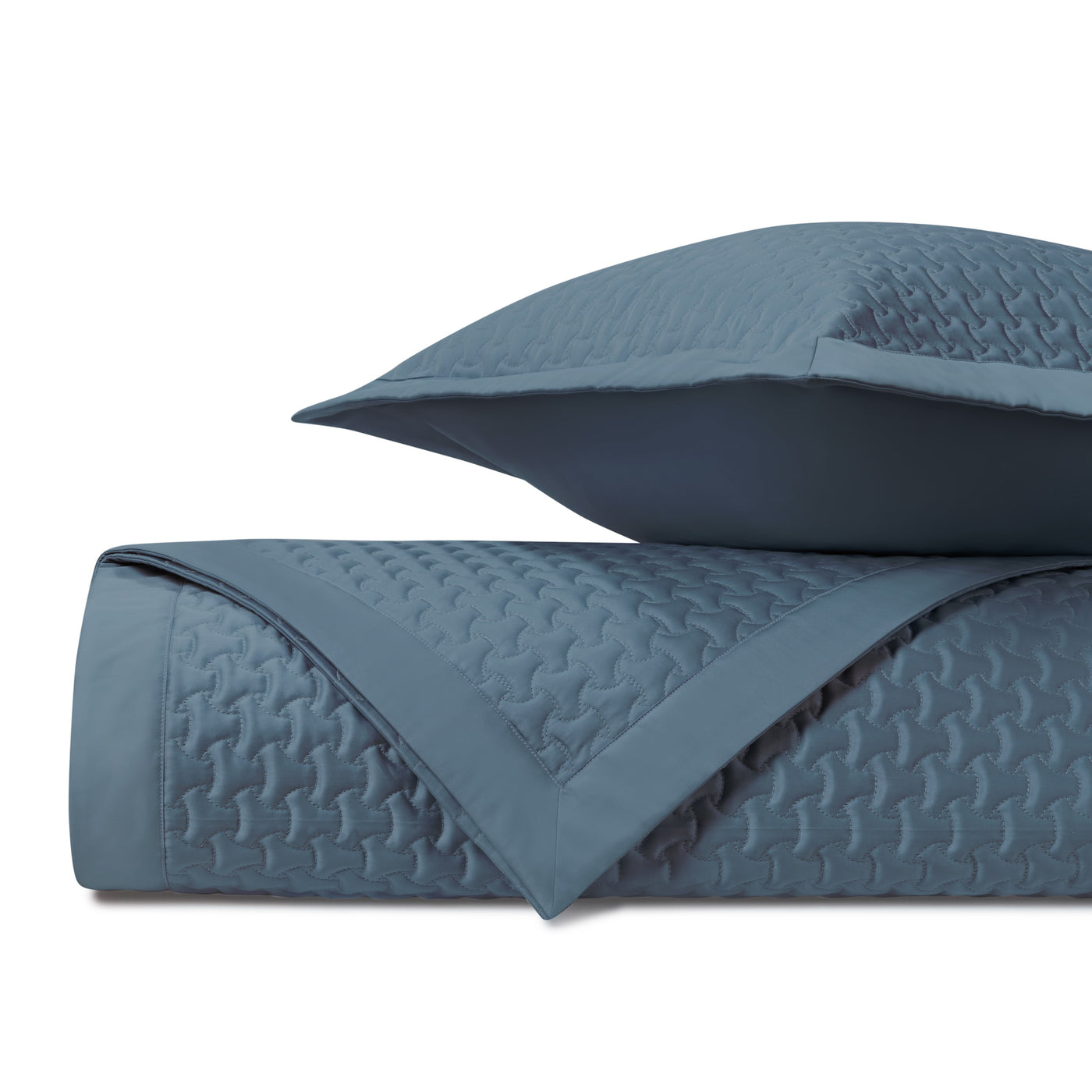 Close-up of Home Treasures Trinity quilted texture in slate blue with geometric stitching.