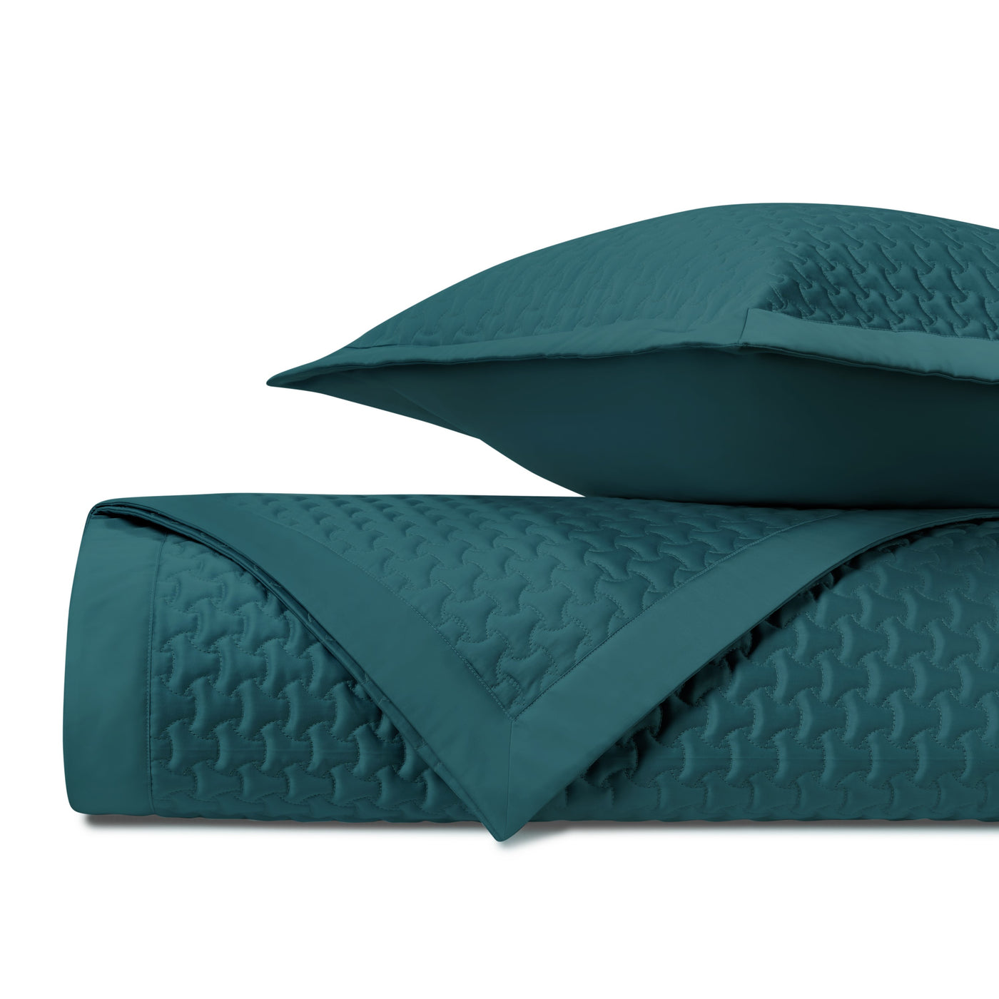 Teal quilted texture close-up showing geometric houndstooth stitching pattern.