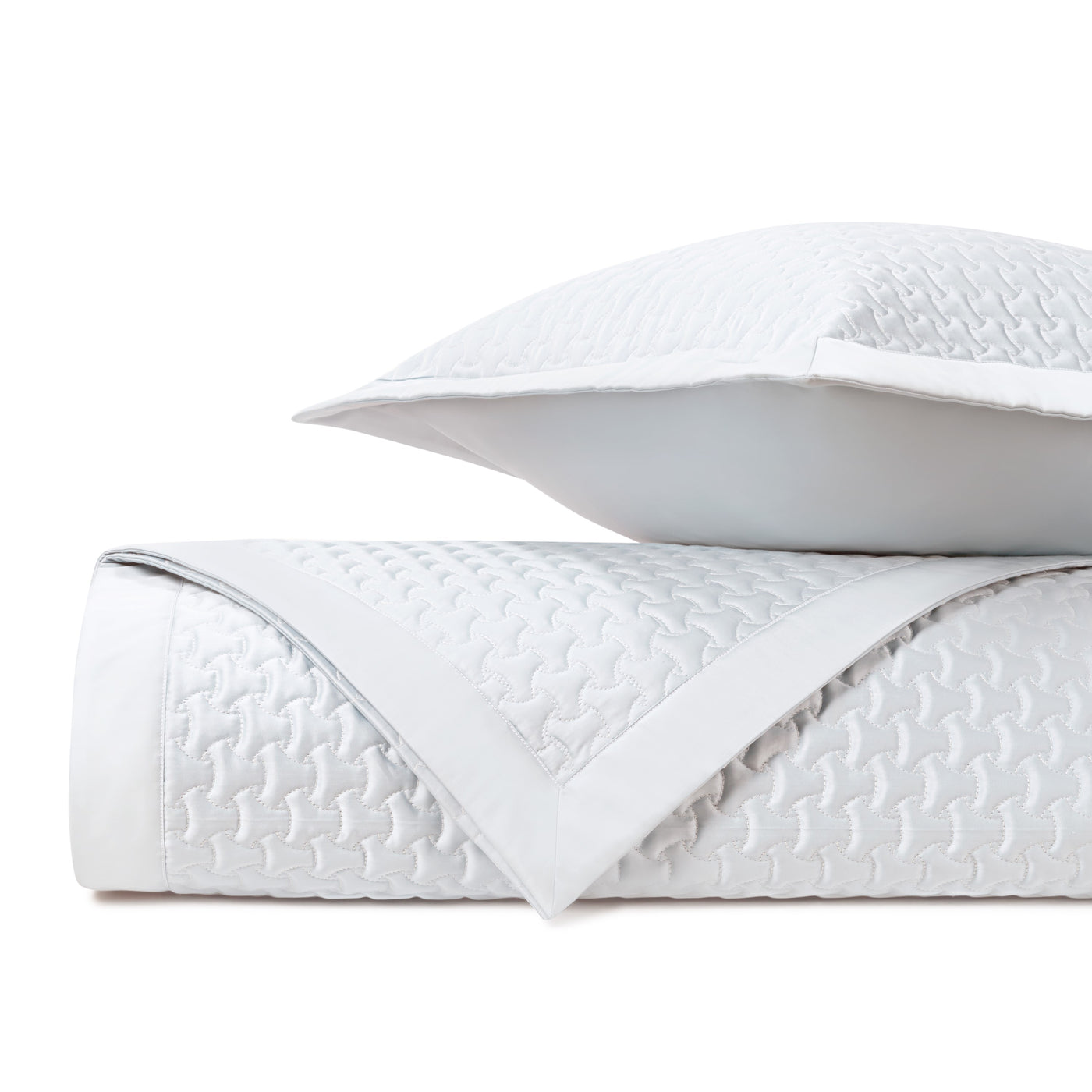 Close-up of Home Treasures Trinity quilted texture in white with geometric stitching detail.