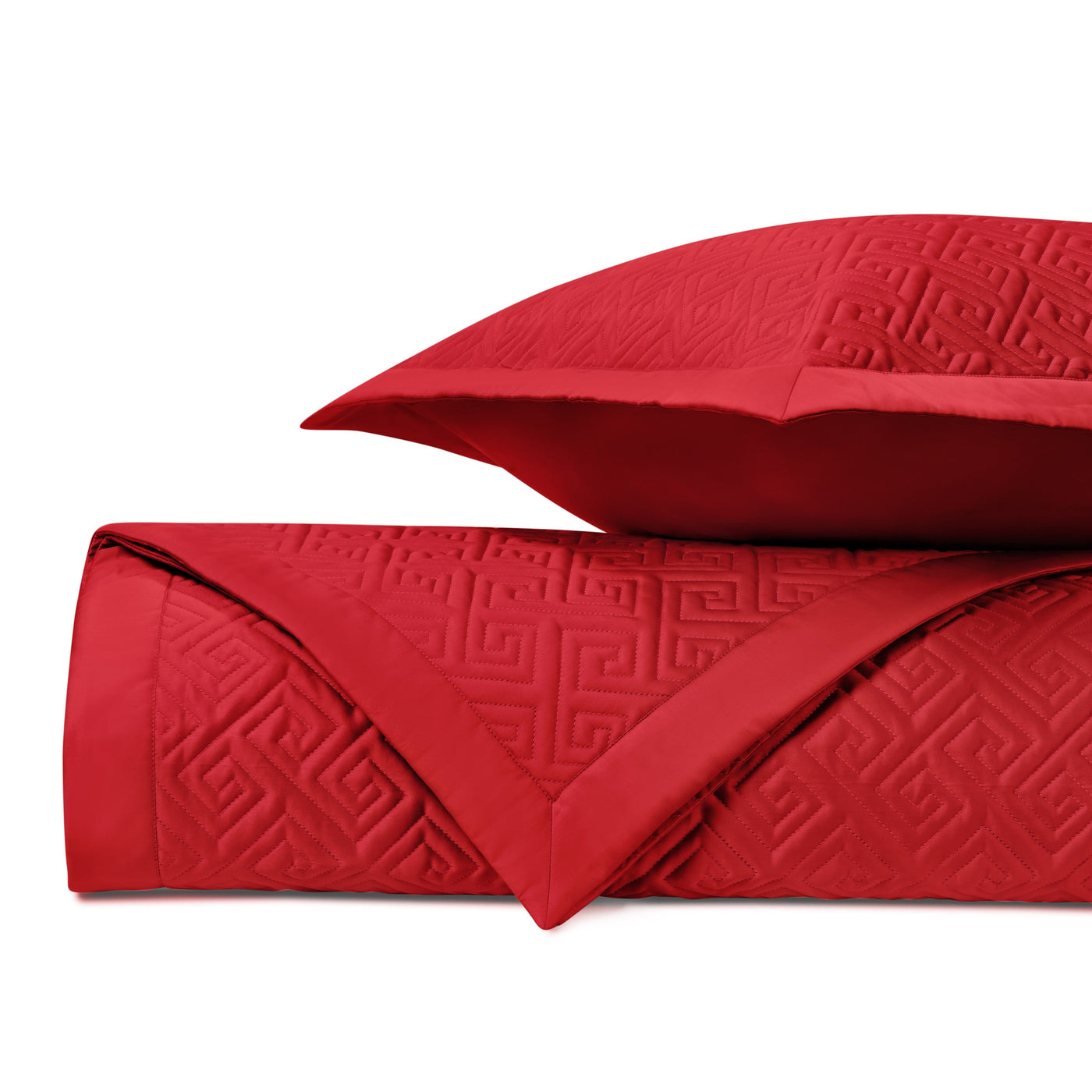 Close-up of red quilted fabric with tone-on-tone Greek key pattern.