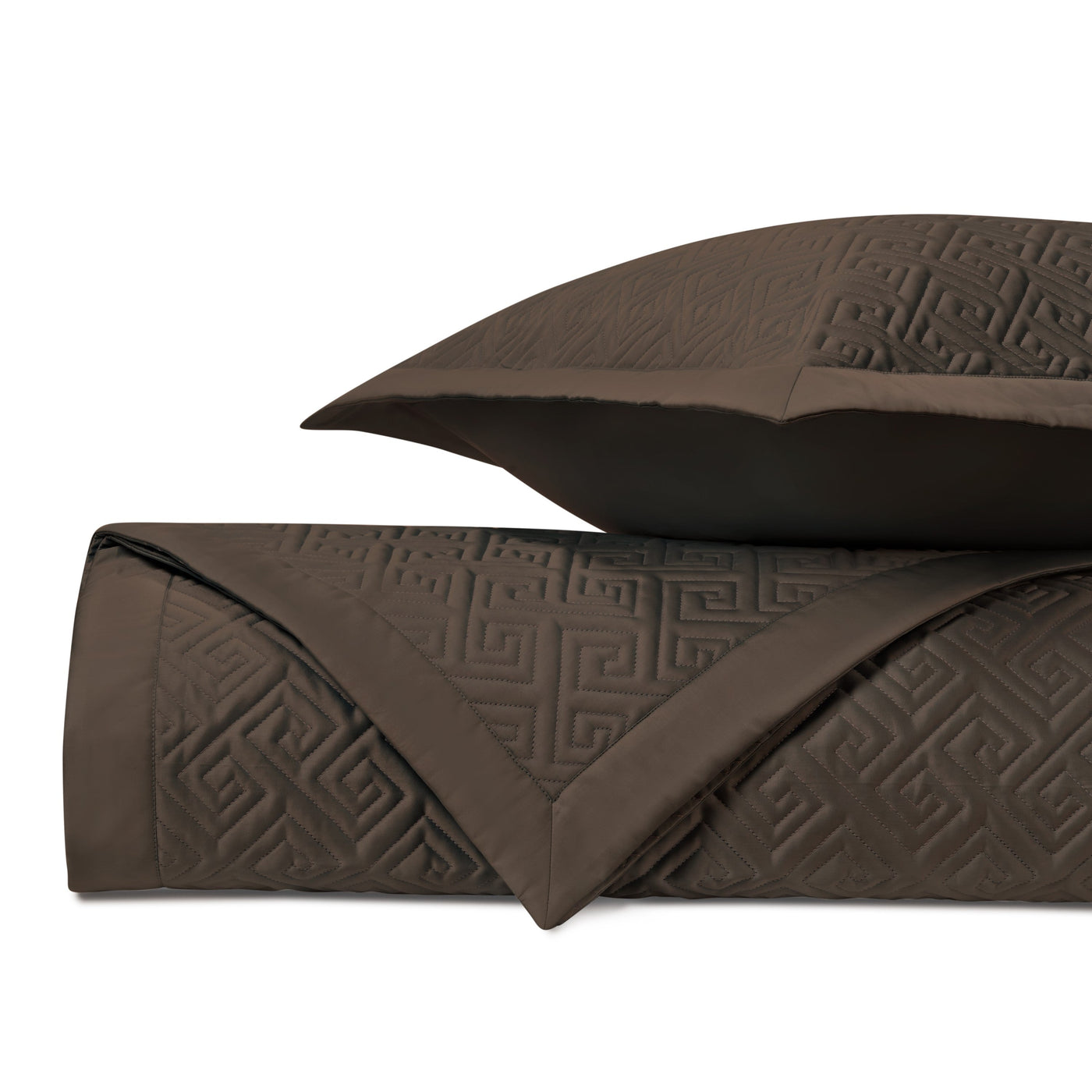 Folded chocolate Troy quilted coverlet showing embossed Greek key pattern detail.