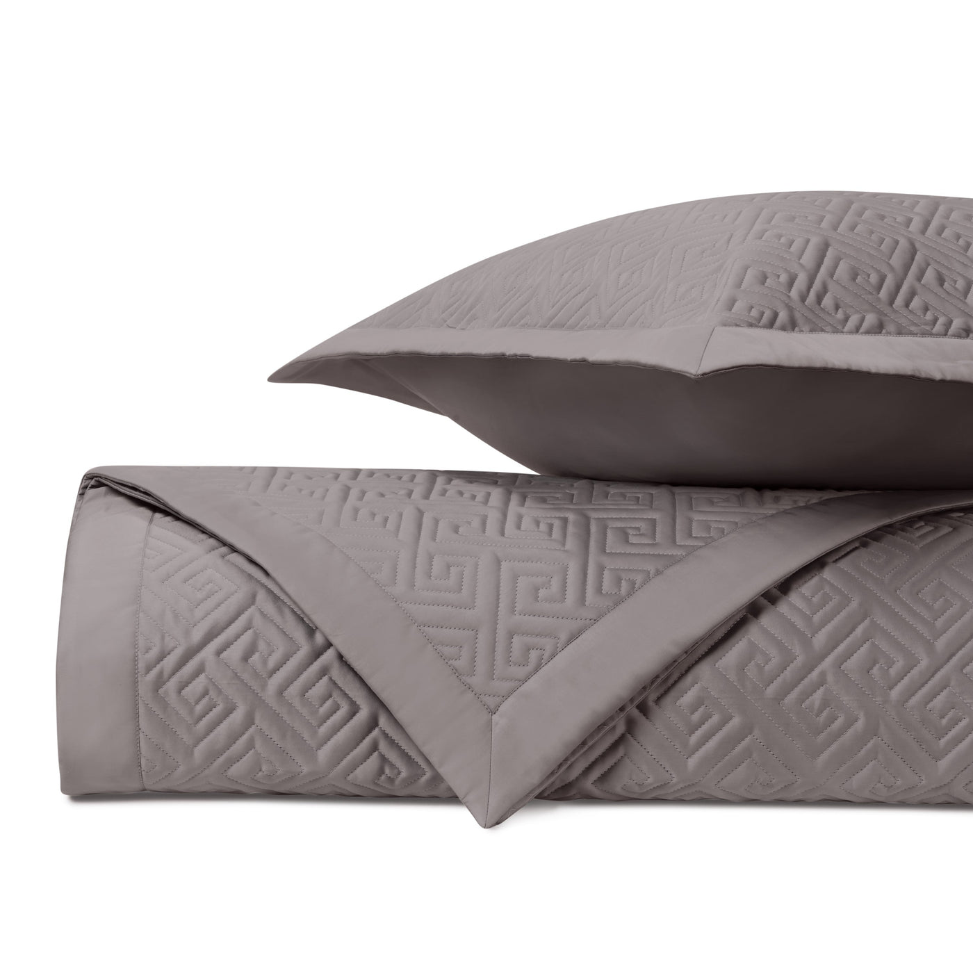 Close-up of Troy quilted coverlet in slate, showing embossed Greek key pattern detail.