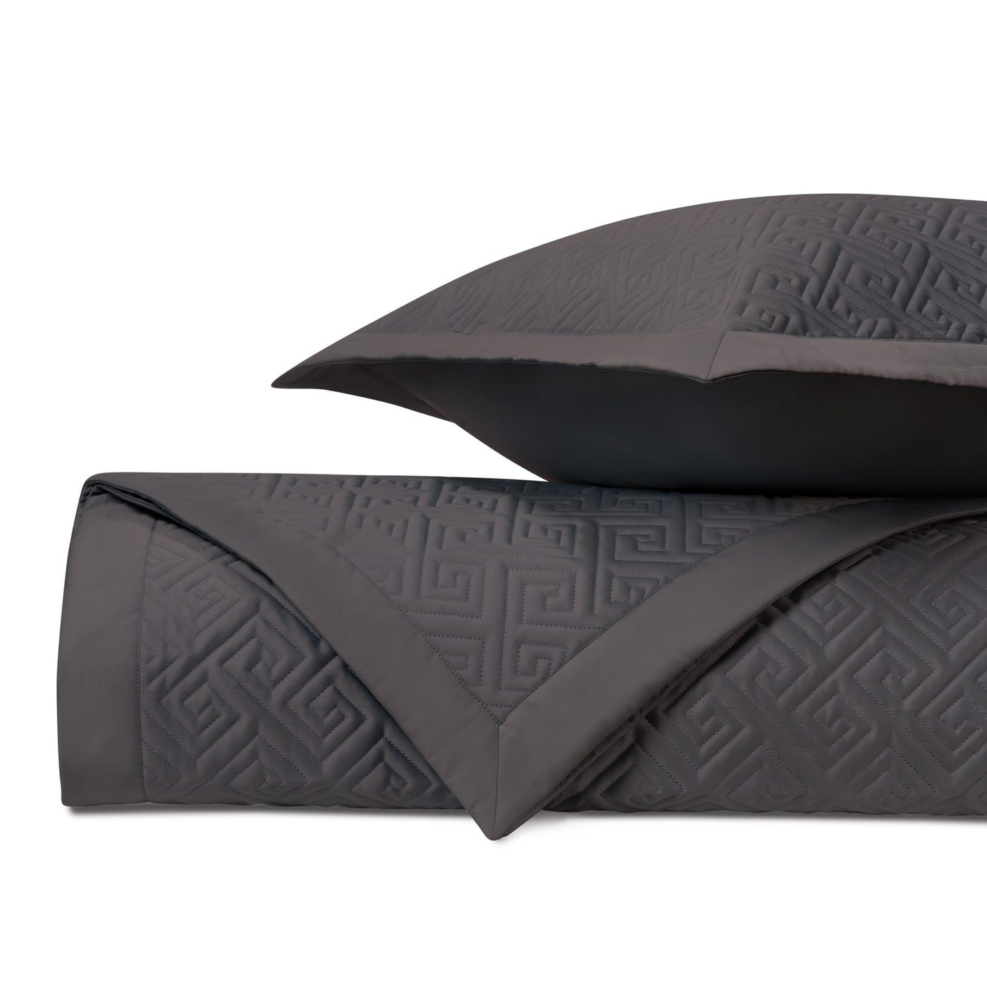 Close-up of Home Treasures Troy quilted coverlet in charcoal with embossed Greek key pattern.