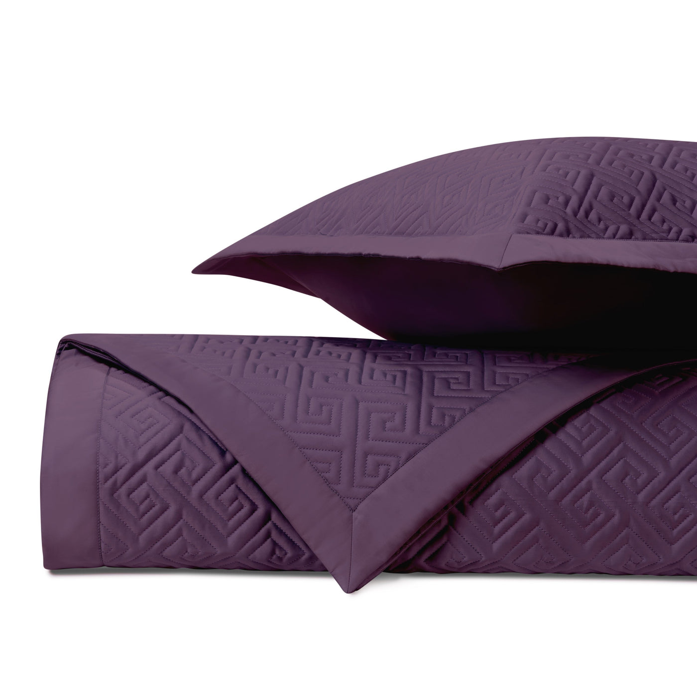 Close-up of Home Treasures Troy quilted coverlet in deep plum with tonal Greek key pattern.