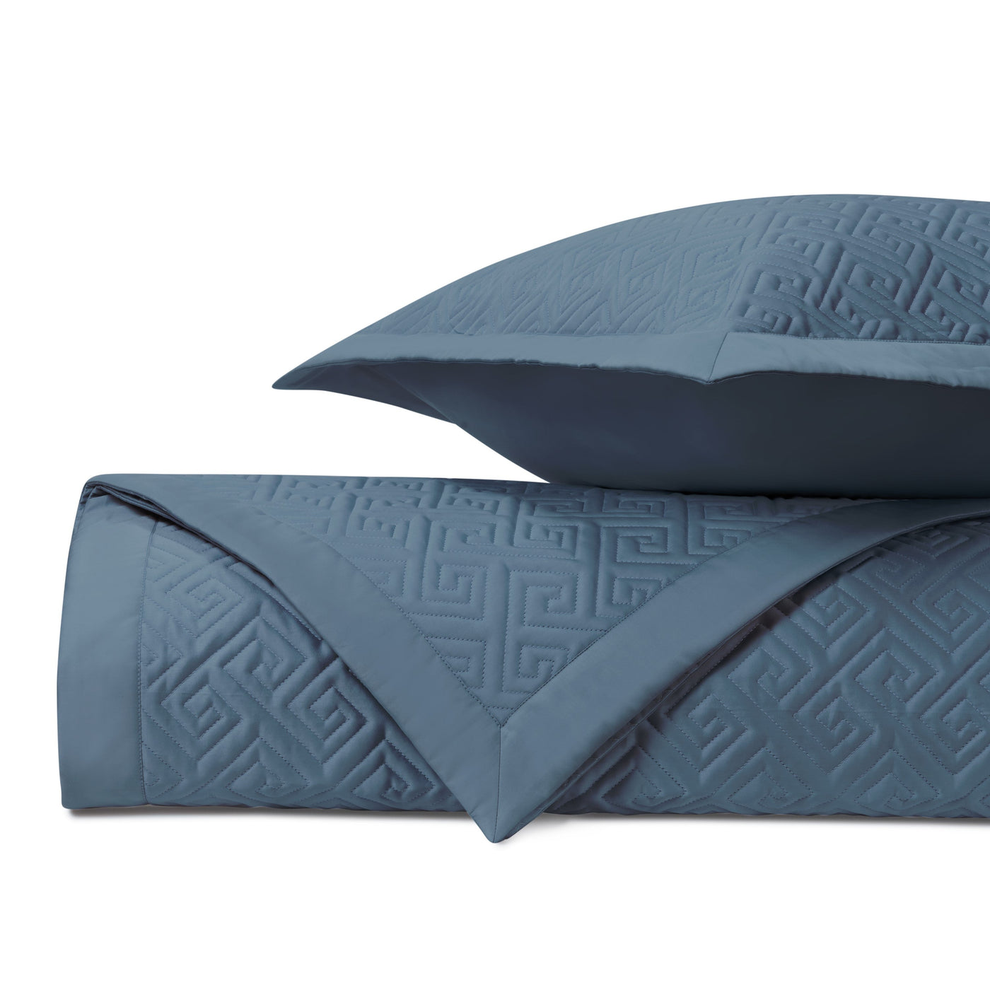Close-up of Home Treasures Troy quilted cotton in slate blue with Greek key motif.