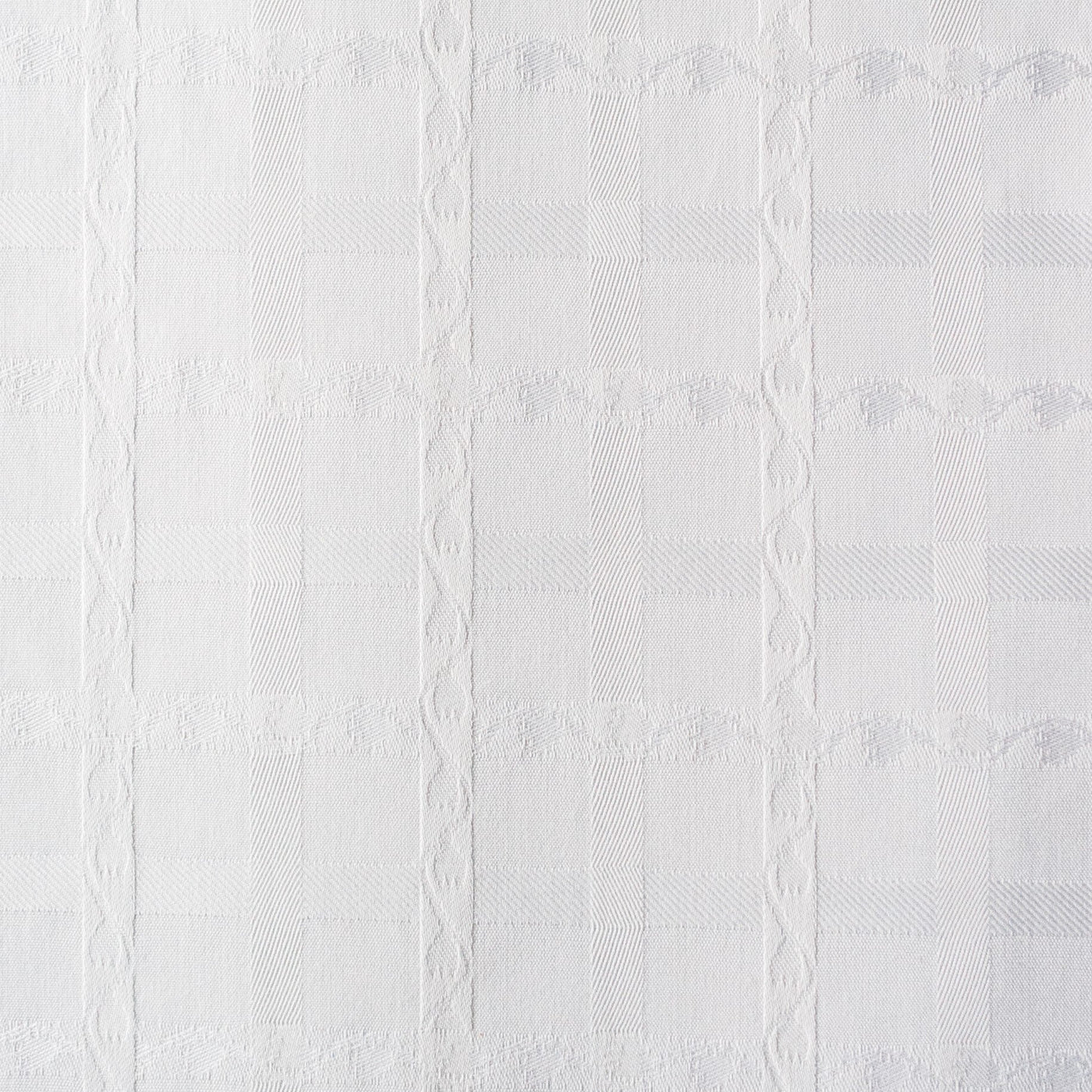 Close-up of Home Treasures Tulips fabric in white, showing woven grid pattern with floral vine detail.
