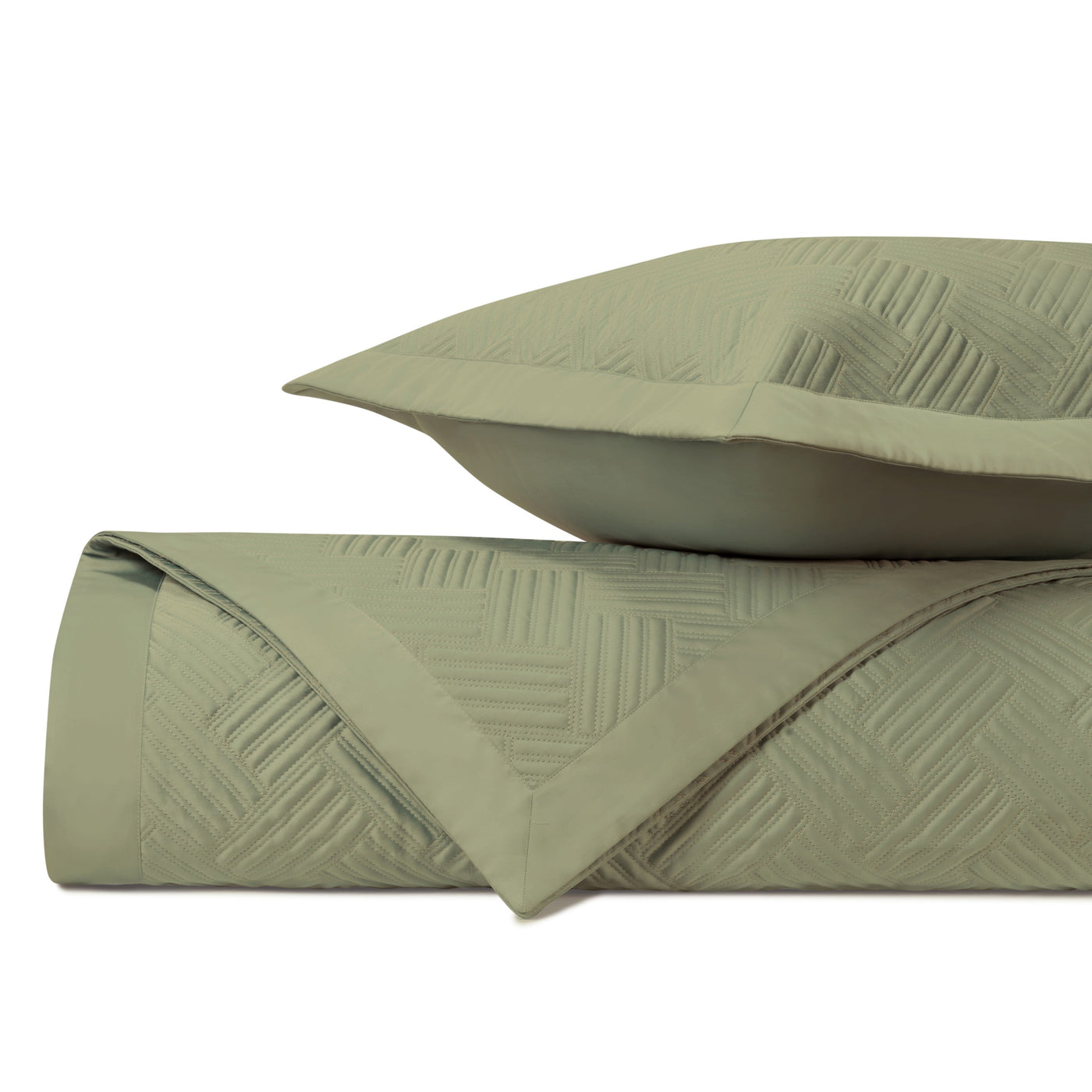 Twilight quilted coverlet close-up in sage, showing geometric diamond stitching detail.