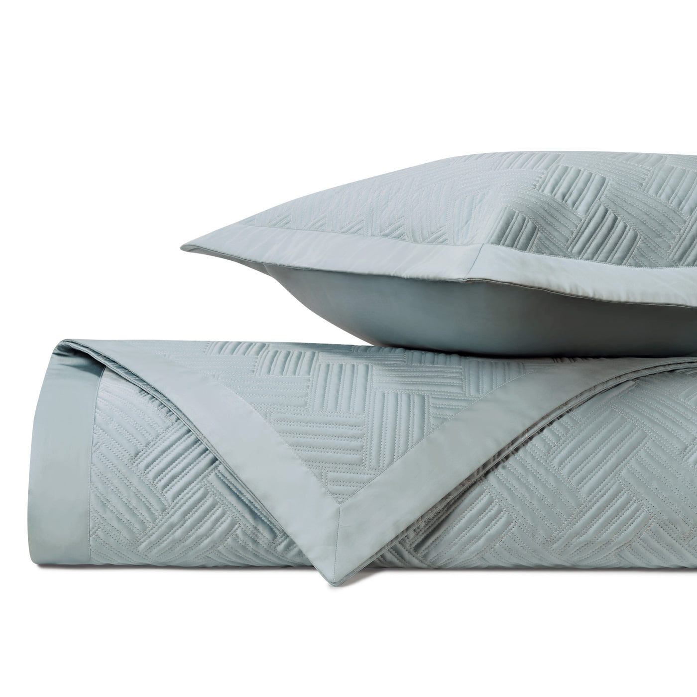 Close-up of Twilight quilted texture in mist blue with woven geometric pattern.