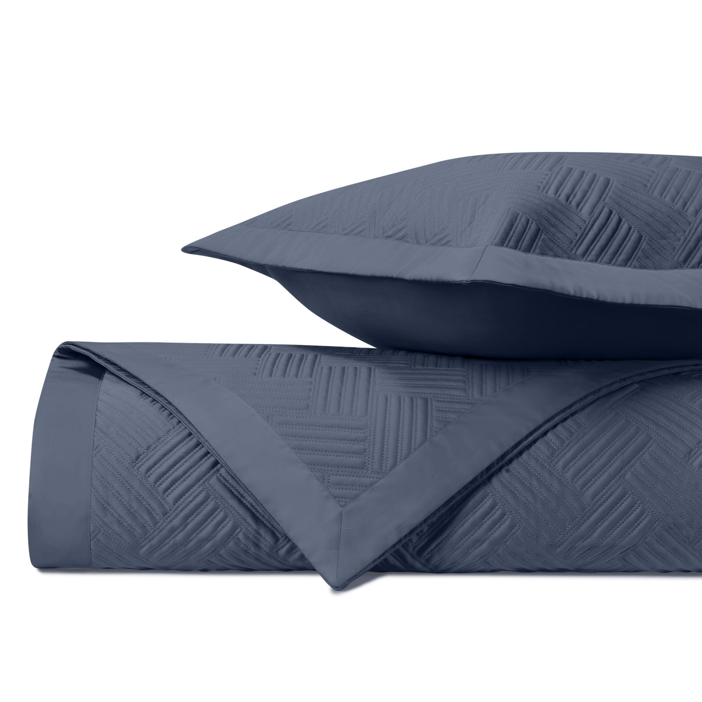 Close-up of navy blue quilted texture with diagonal crosshatch stitching pattern.