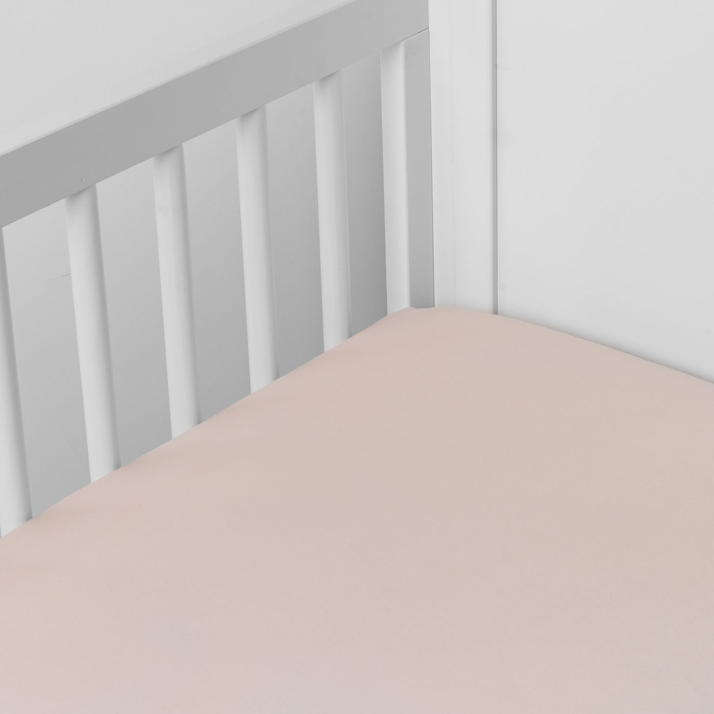 Pearl Madera Luxe crib sheet fitted on a white crib, soft matte finish visible.
