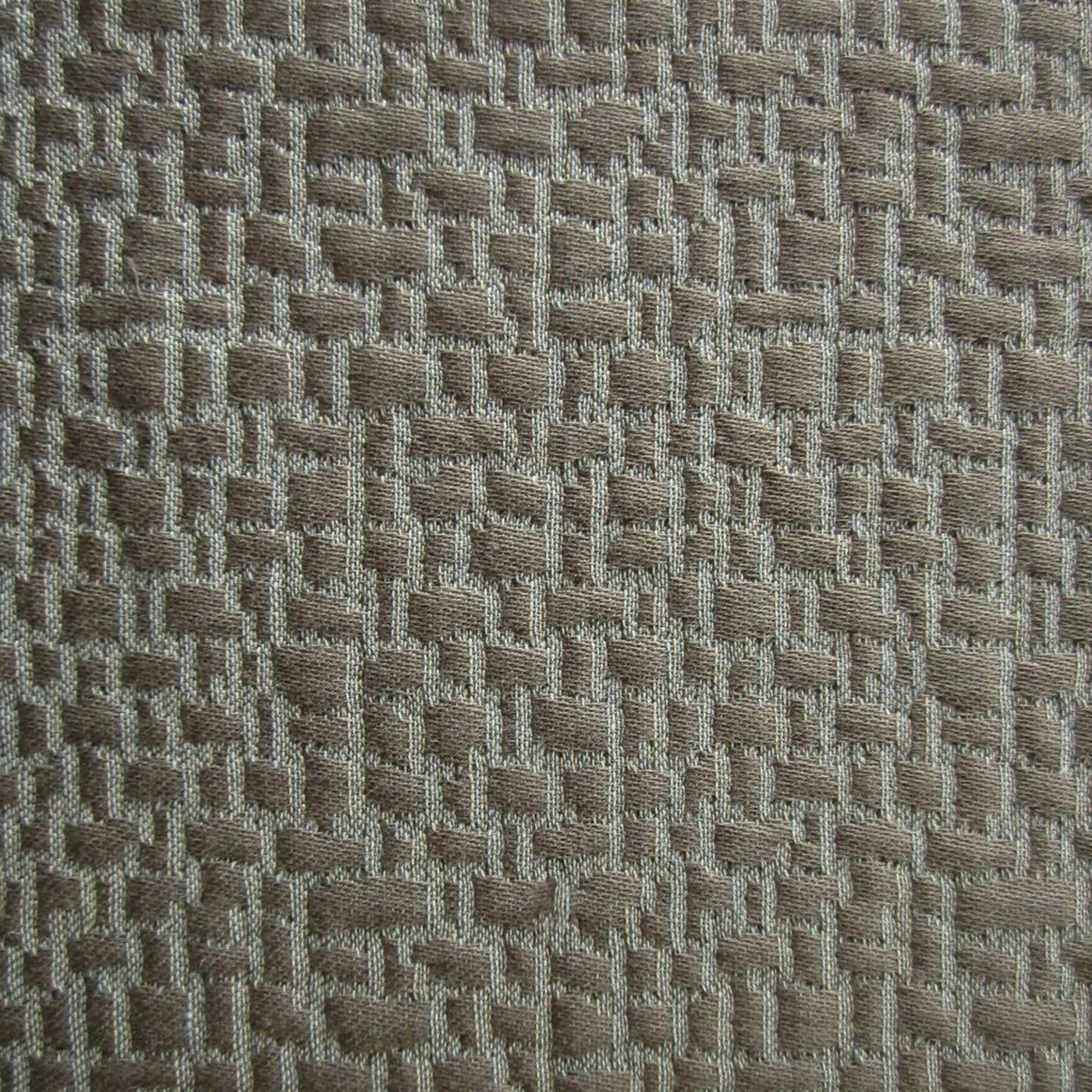 Close-up of taupe matelassé weave showing raised basketweave texture detail.