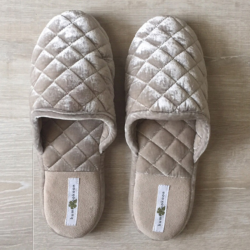 Kumi Kookoon Velvet Quilted Slippers in beige are displayed side by side on a light wood floor.