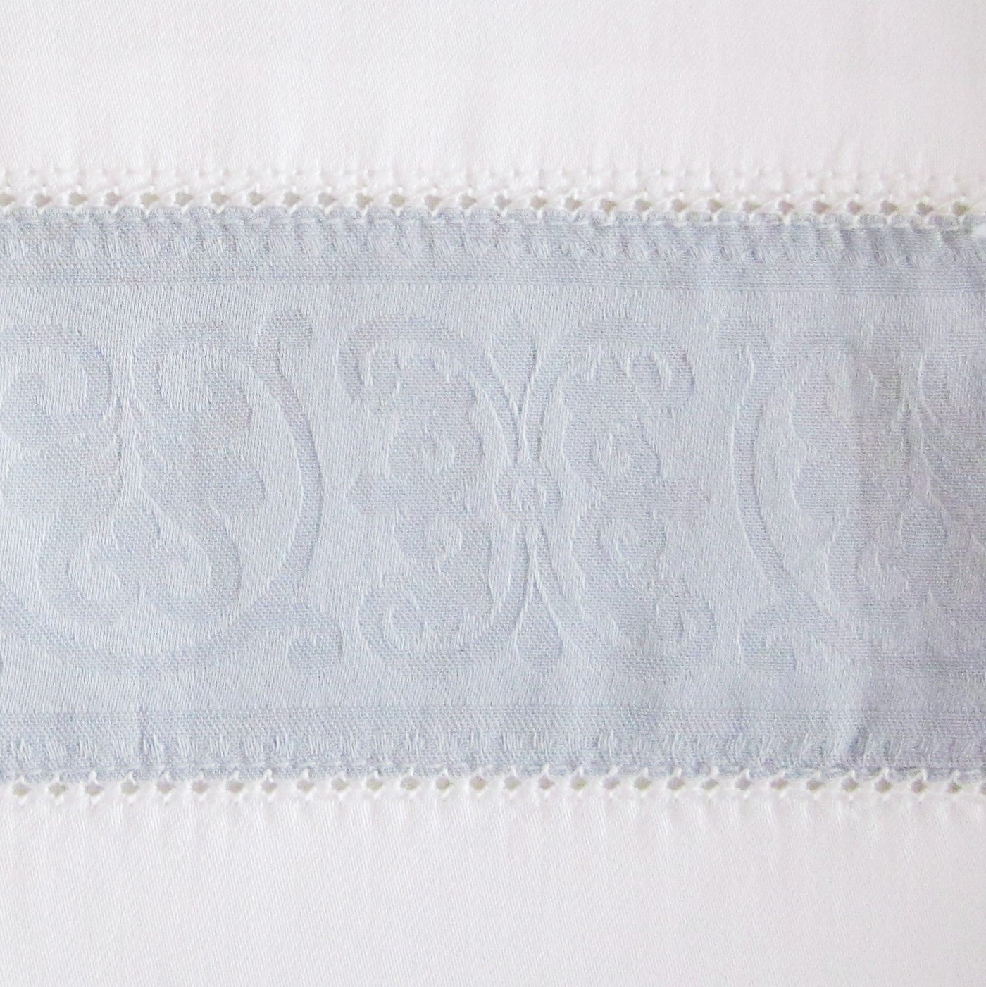 Close-up of Venice pale blue jacquard border with ornate scrollwork and crochet trim detail.