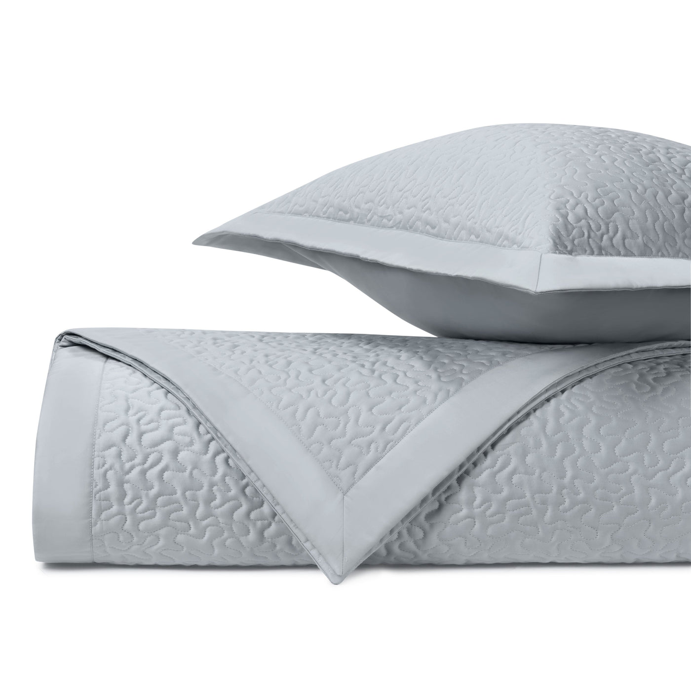Vermicelli quilted texture in mist blue, folded coverlet with matching sham detail.