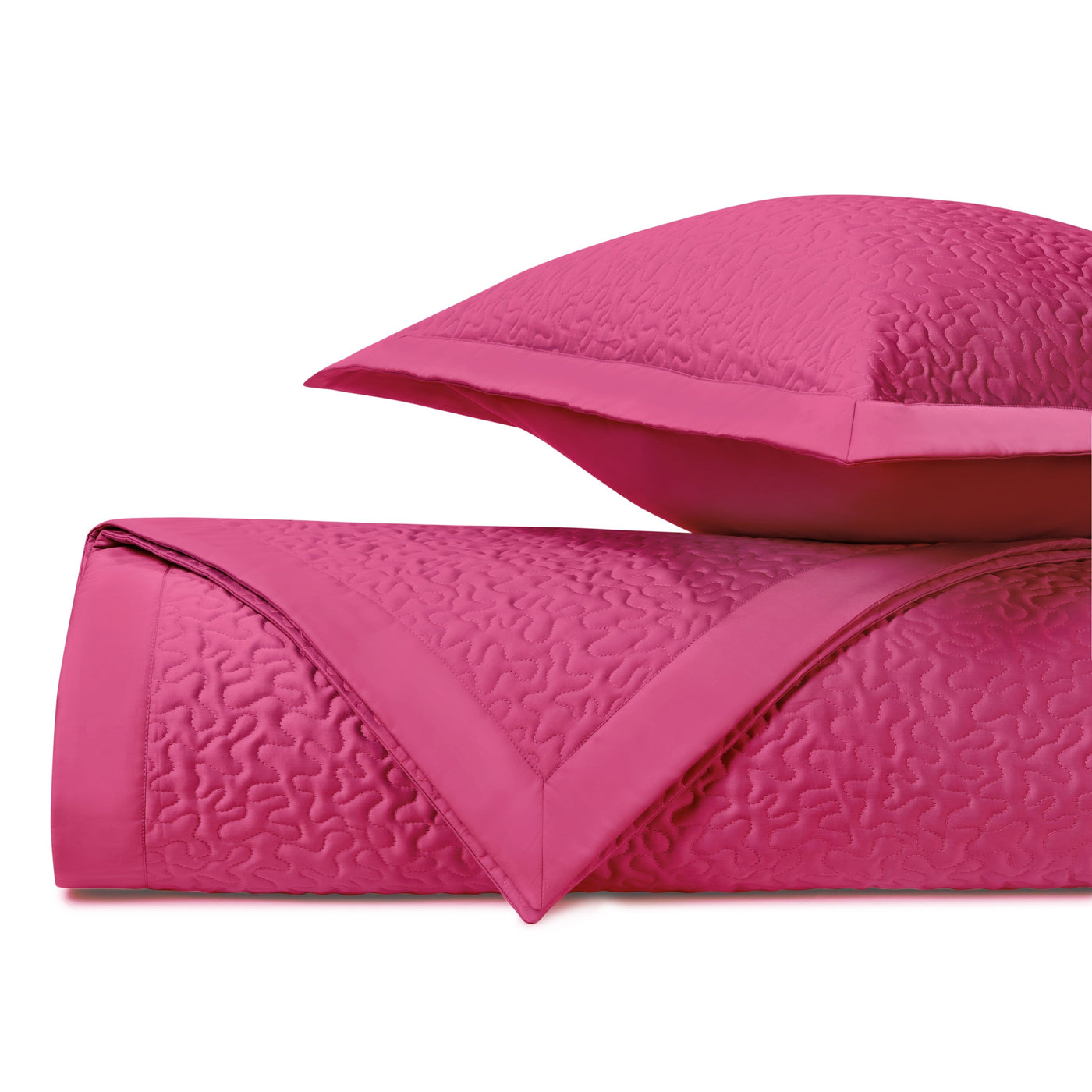 Fuchsia quilted texture close-up with flange-edge sham detail visible behind.
