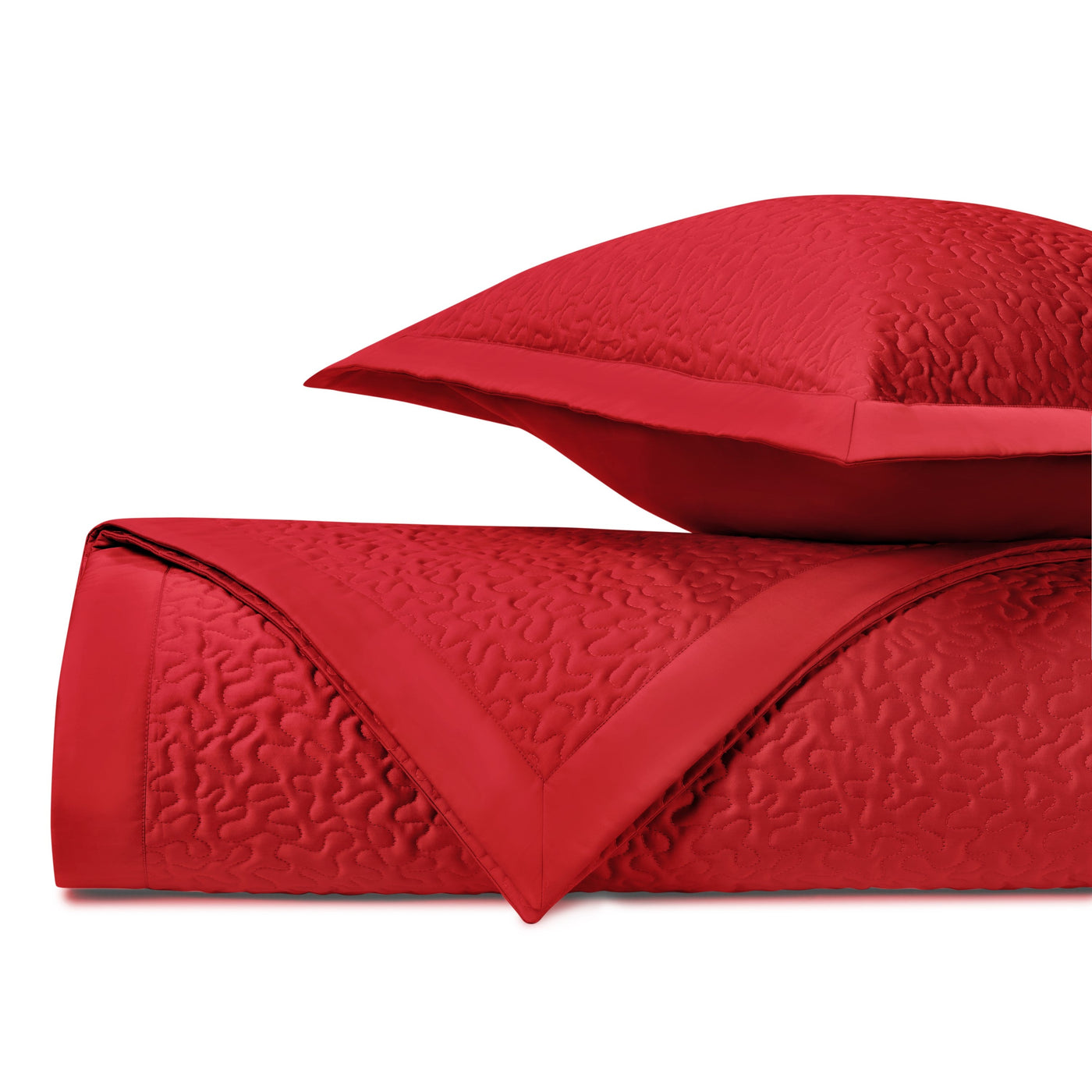 Close-up of crimson quilted texture with vermicelli stitching pattern and satin border trim.