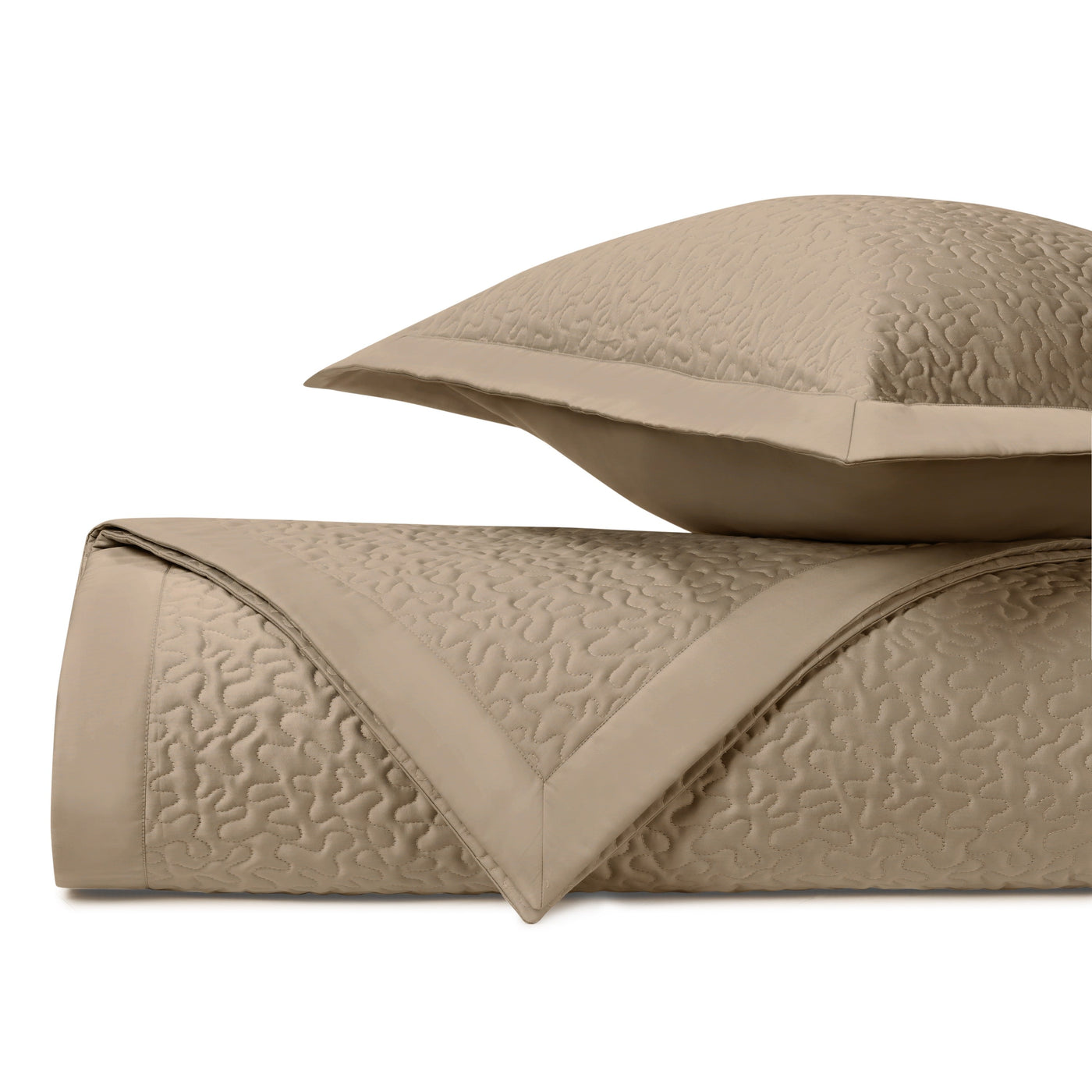 Close-up of Home Treasures Vermicelli quilted texture in camel with satin border detail.