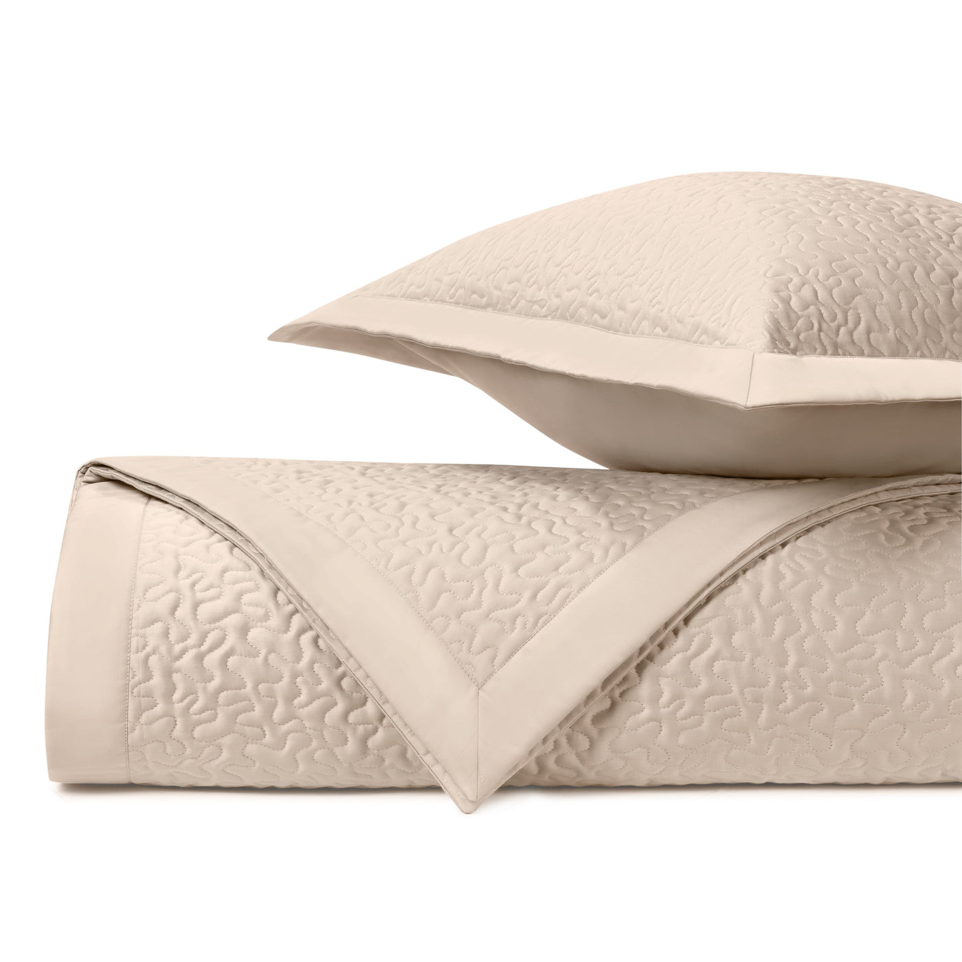 Close-up of ivory quilted Vermicelli pattern with intricate swirling stitched texture.