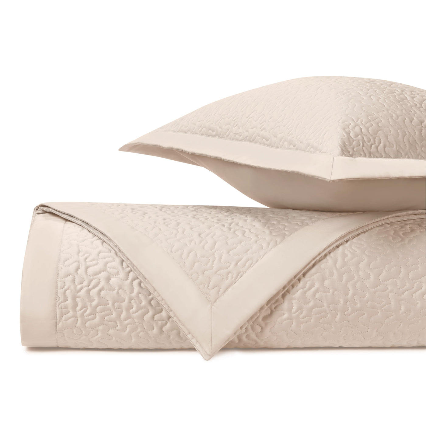 Close-up of Home Treasures Vermicelli quilted texture in ivory with flange border detail.