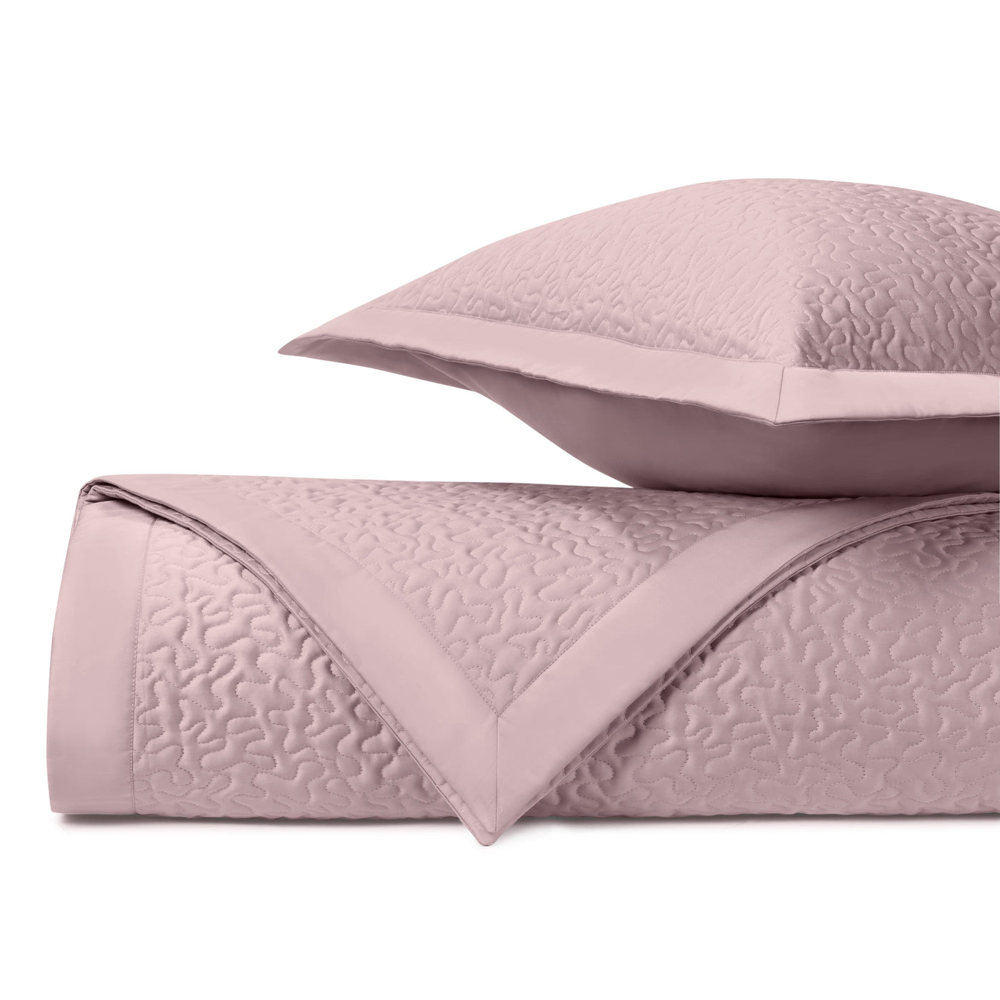 Close-up of Home Treasures Vermicelli quilted coverlet in blush with textured stitching.