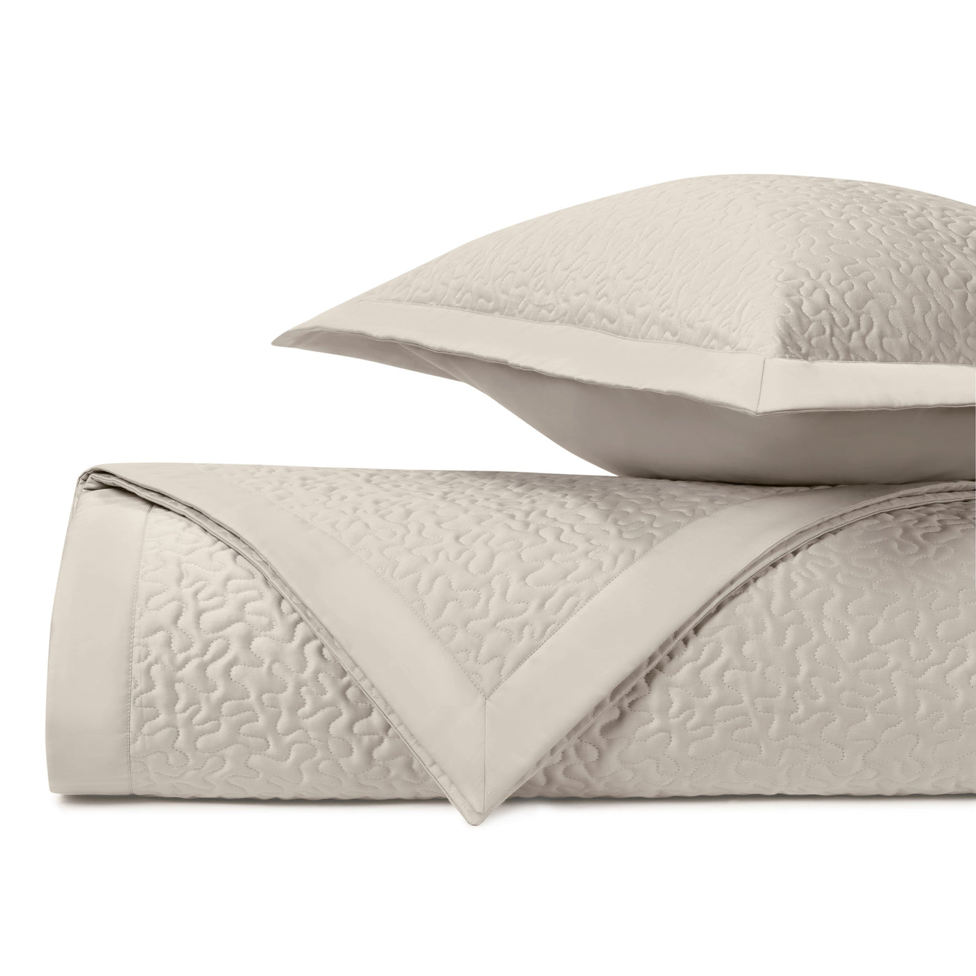 Close-up of Home Treasures Vermicelli quilted coverlet and sham in ivory.