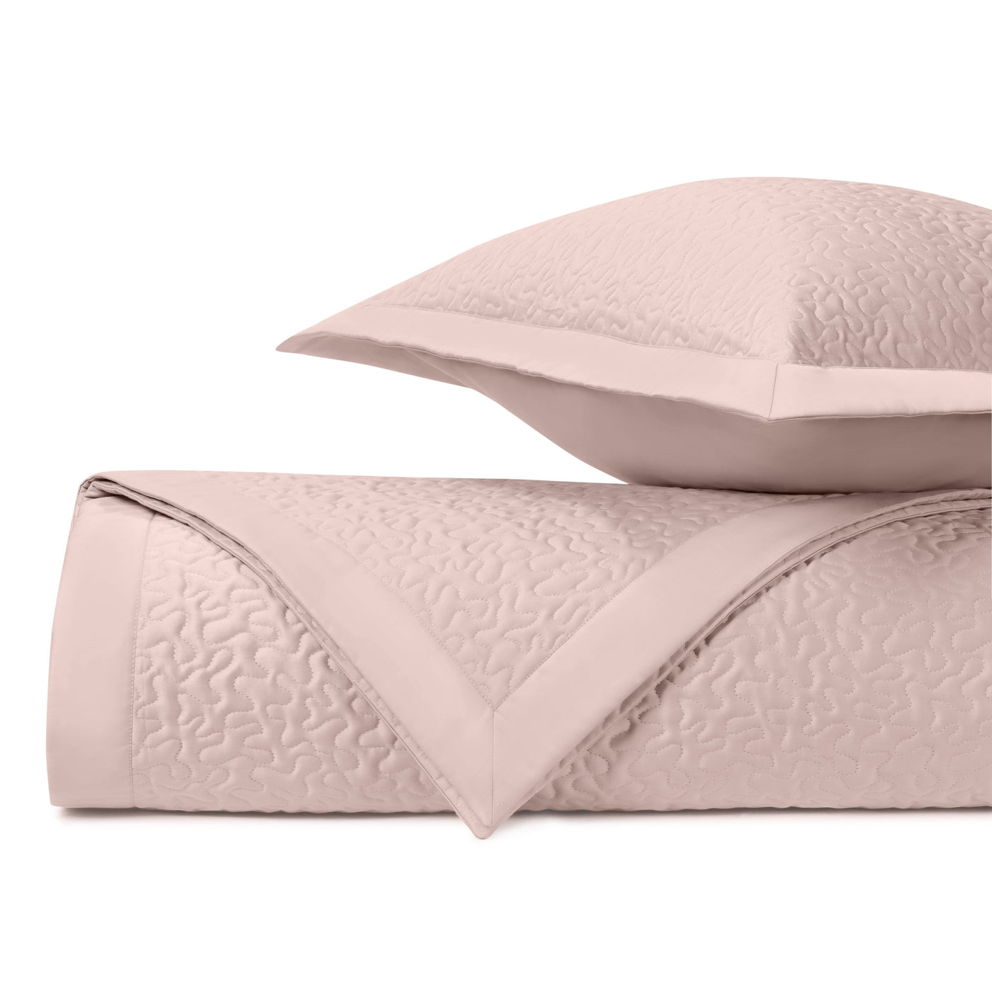 Close-up of Home Treasures Vermicelli quilted coverlet in blush with textured stitching detail.