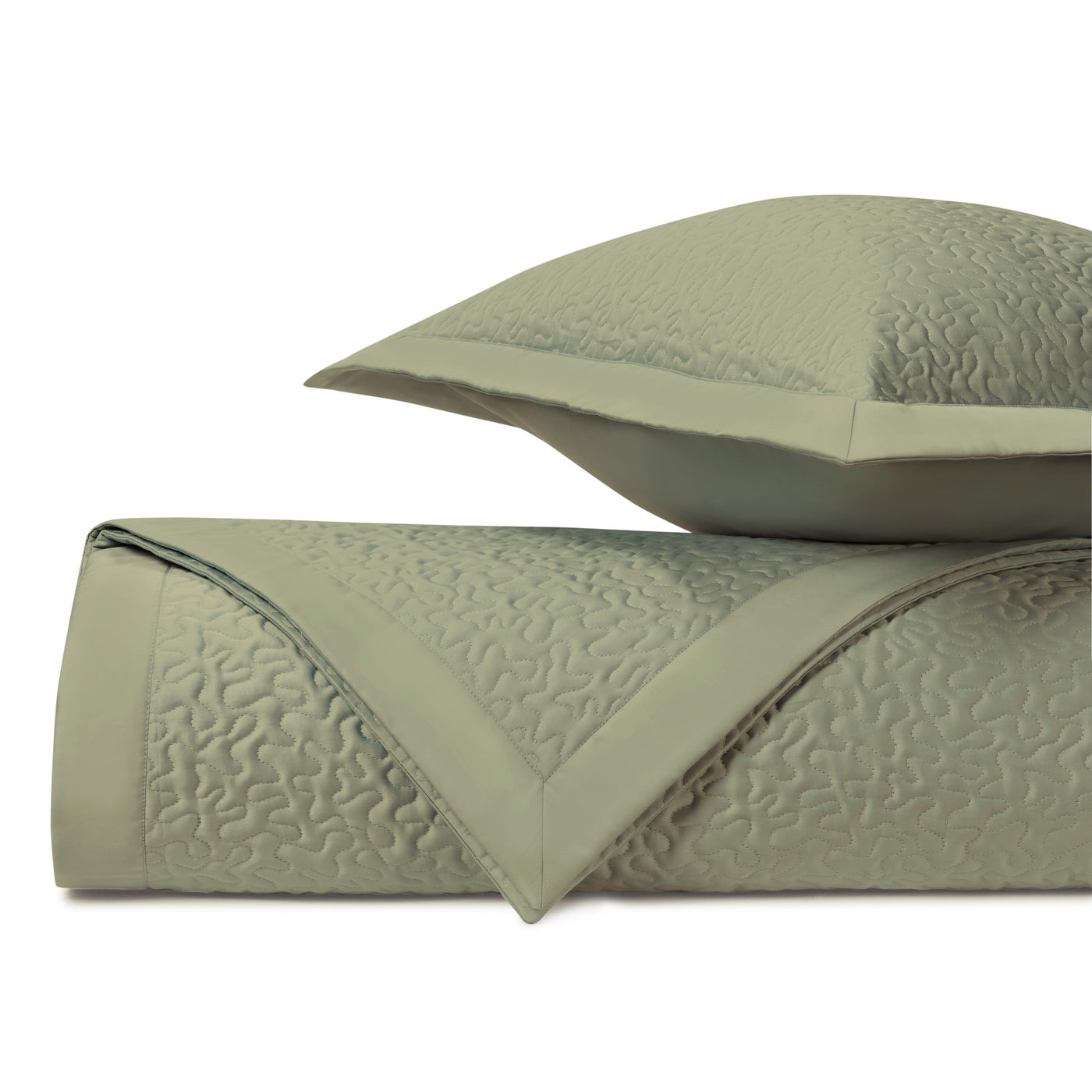 Sage green quilted coverlet and sham with tone-on-tone vermicelli stitching, folded.