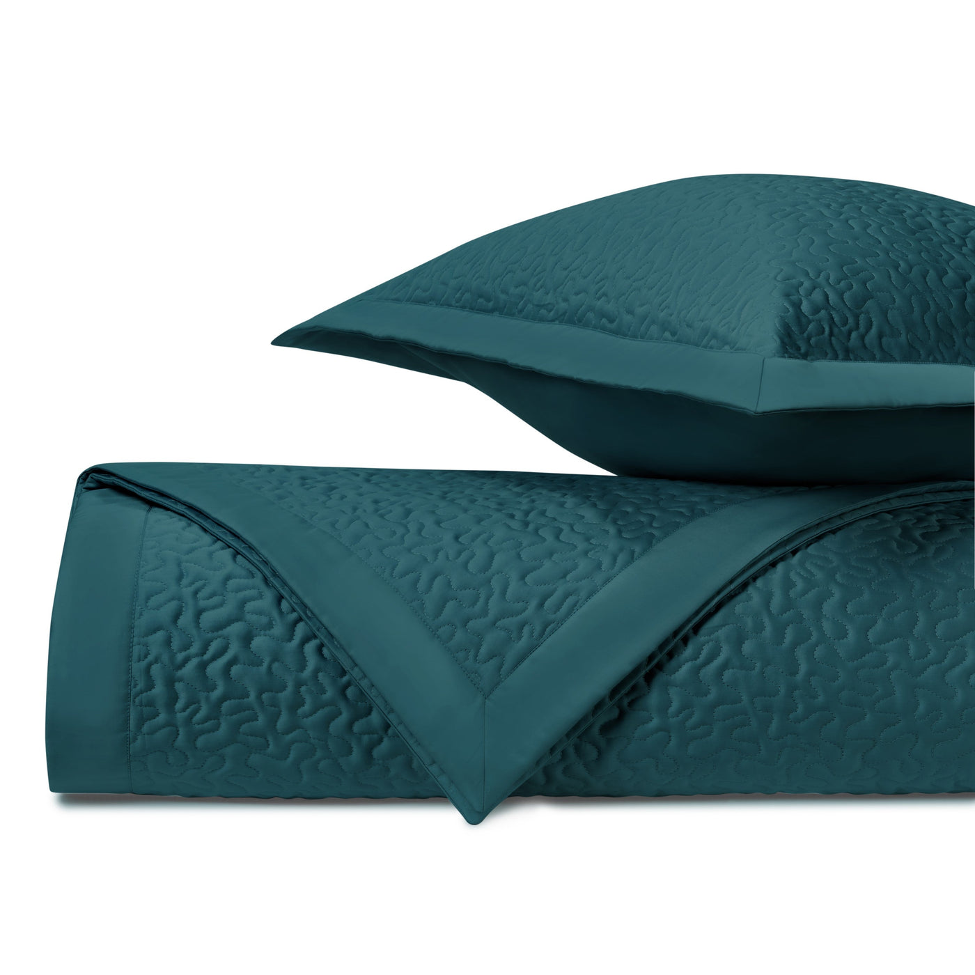 Teal quilted texture close-up showing vermicelli stitching pattern and border detail.