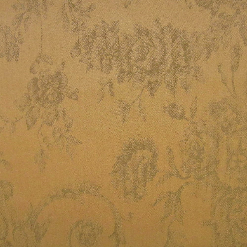 Close-up of champagne damask fabric with tone-on-tone woven floral and rose pattern.