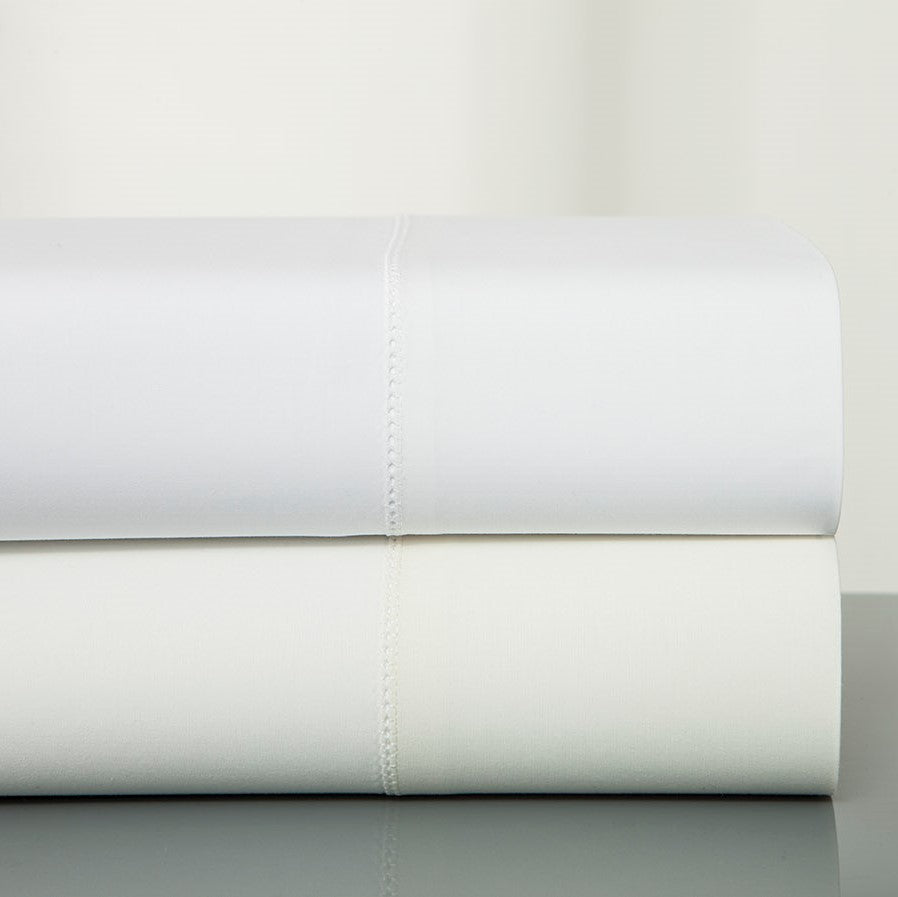 Home Treasures Villa white cotton yardage folded in two stacked rolls.