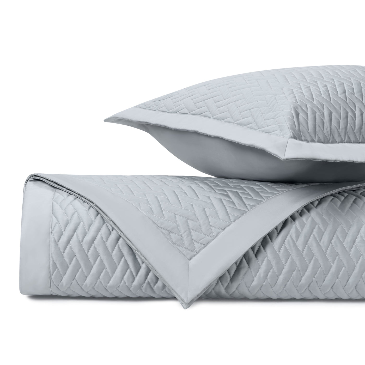 Close-up of Viscaya quilted coverlet in silver with geometric diamond stitching detail.