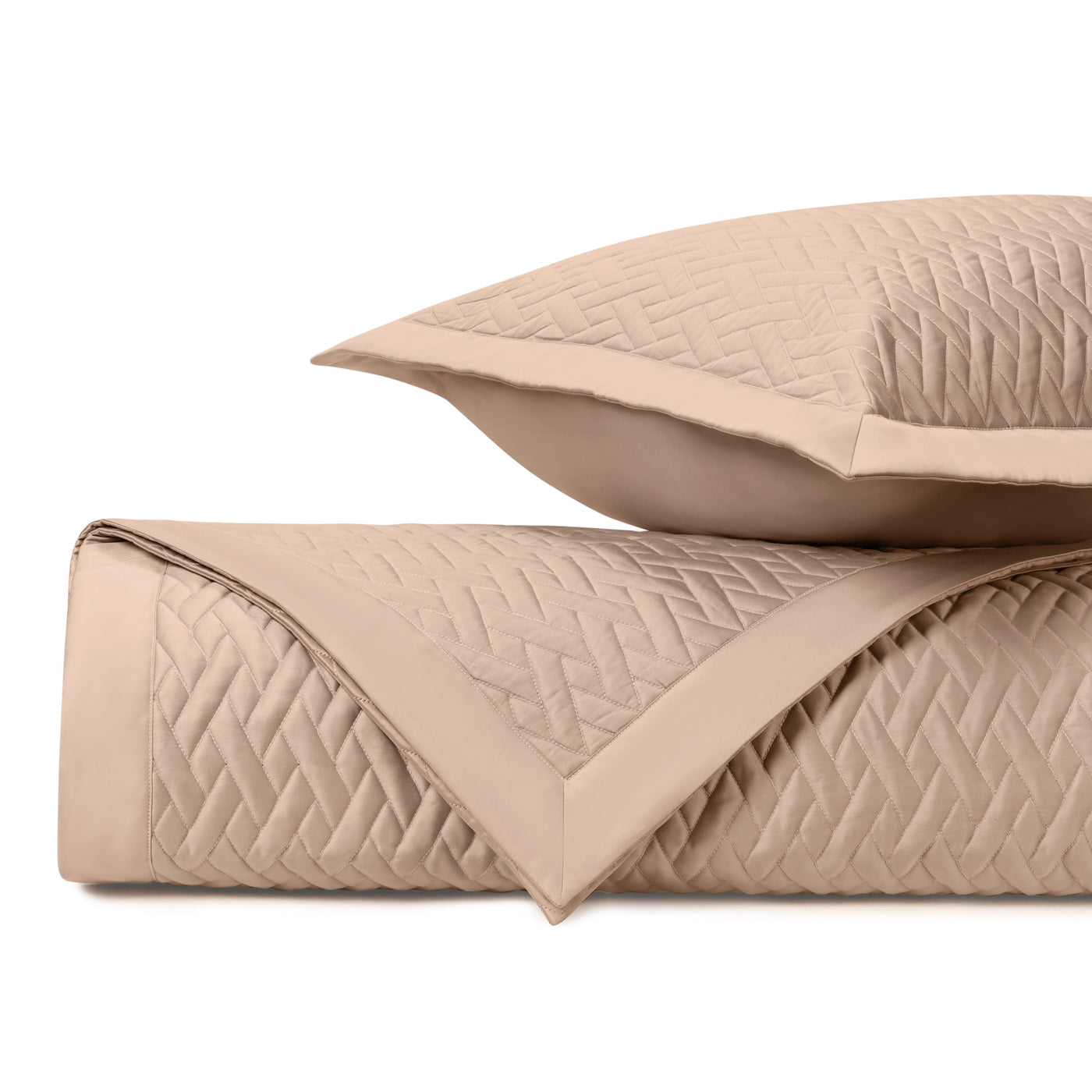 Close-up of Viscaya quilted coverlet and sham in blush, showing diamond stitch pattern.