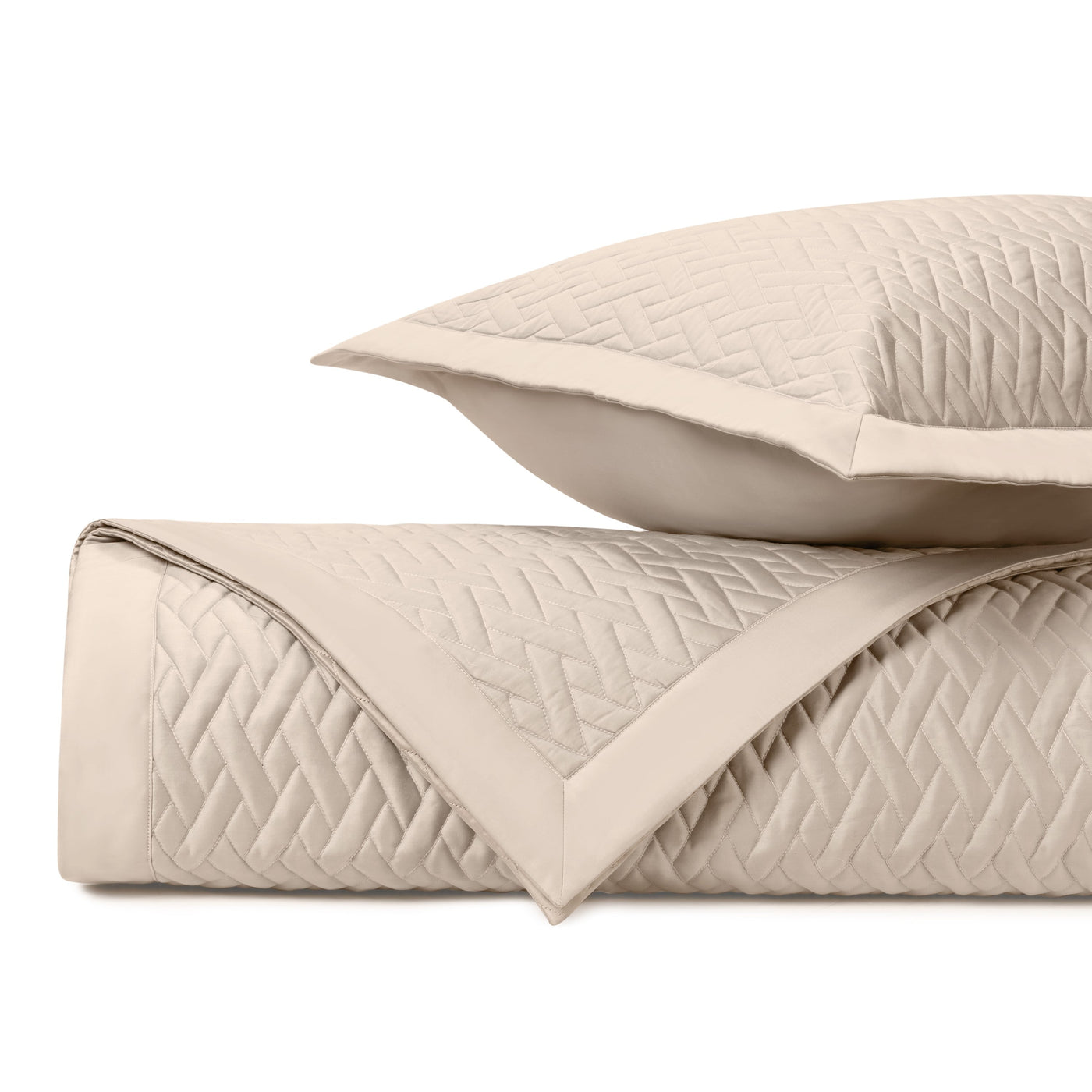 Viscaya quilted coverlet and sham in ivory, showing diamond stitch pattern detail.