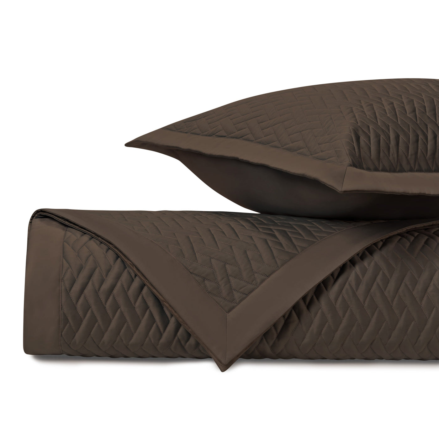 Close-up of chocolate quilted yardage with geometric diamond stitching pattern and coordinating sham.