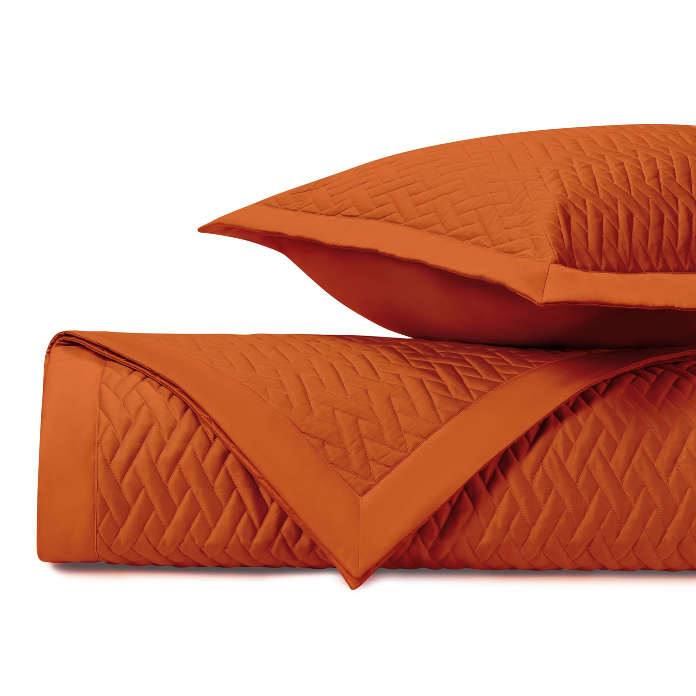 Close-up of Home Treasures Viscaya quilted coverlet in tangerine with diamond stitching.