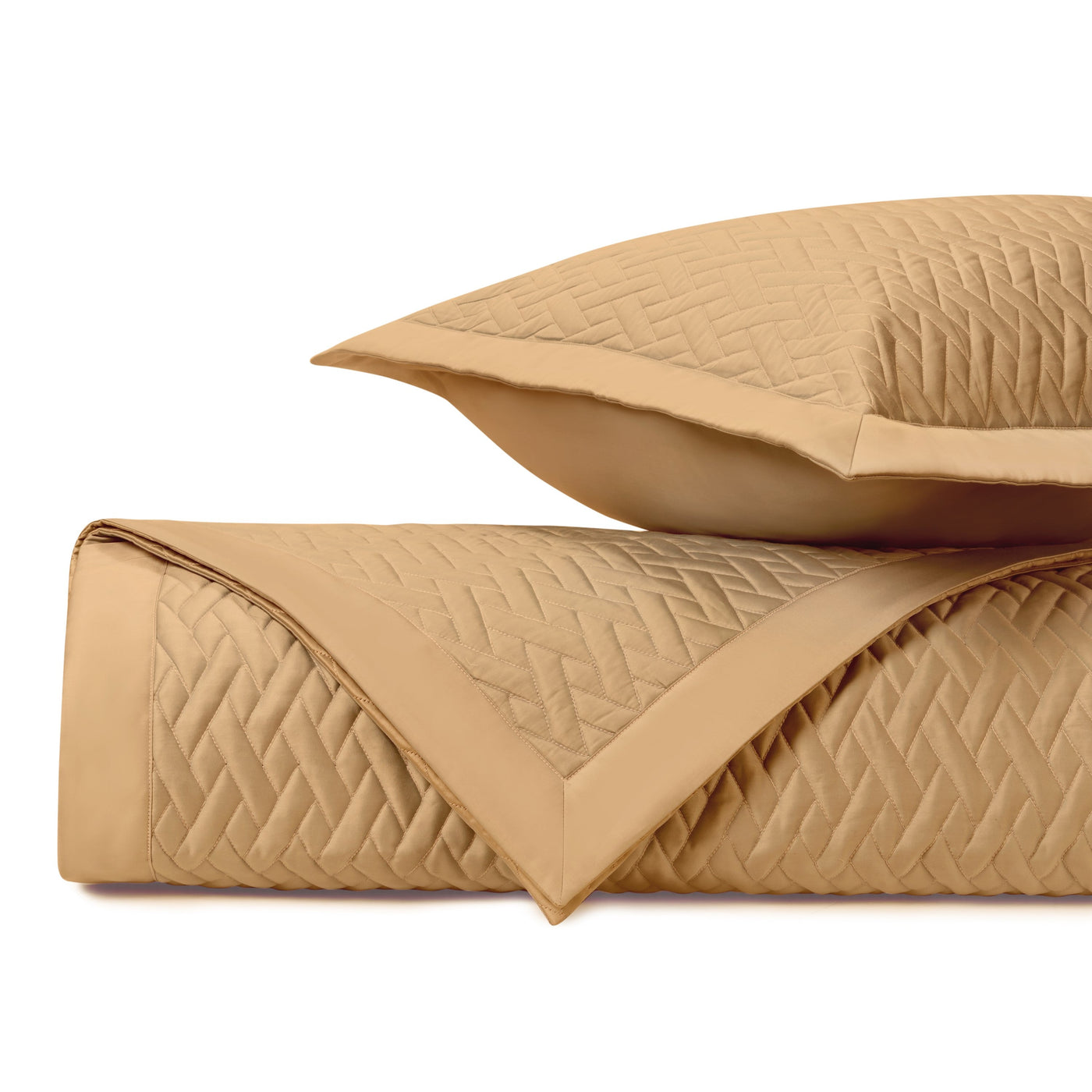 Close-up of Home Treasures Viscaya quilted coverlet in camel with diamond stitching detail.