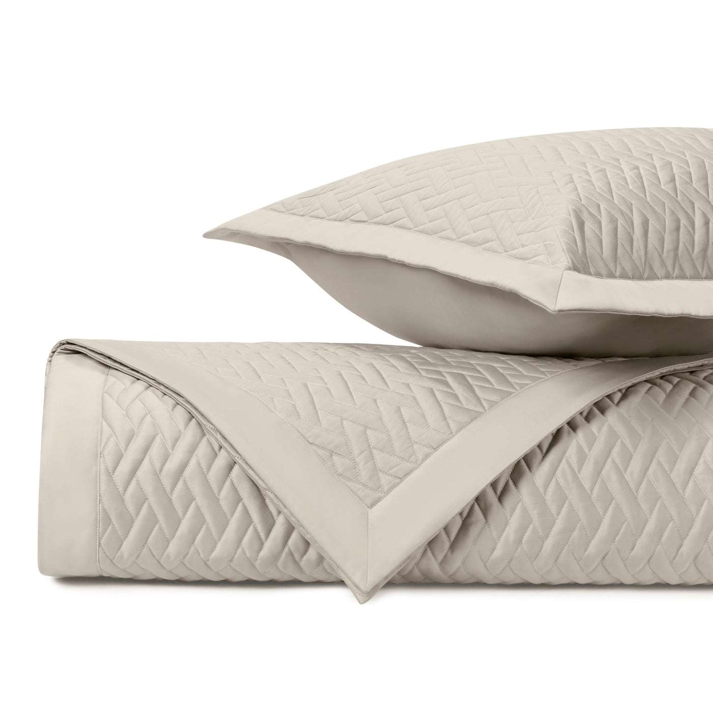 Viscaya quilted coverlet and sham in oyster, showing diamond stitch pattern detail.