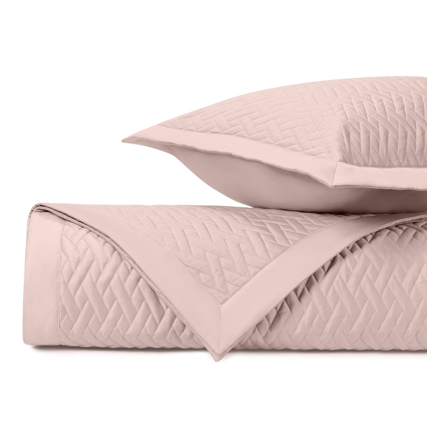 Close-up of Home Treasures Viscaya quilted coverlet in blush with diamond stitching.