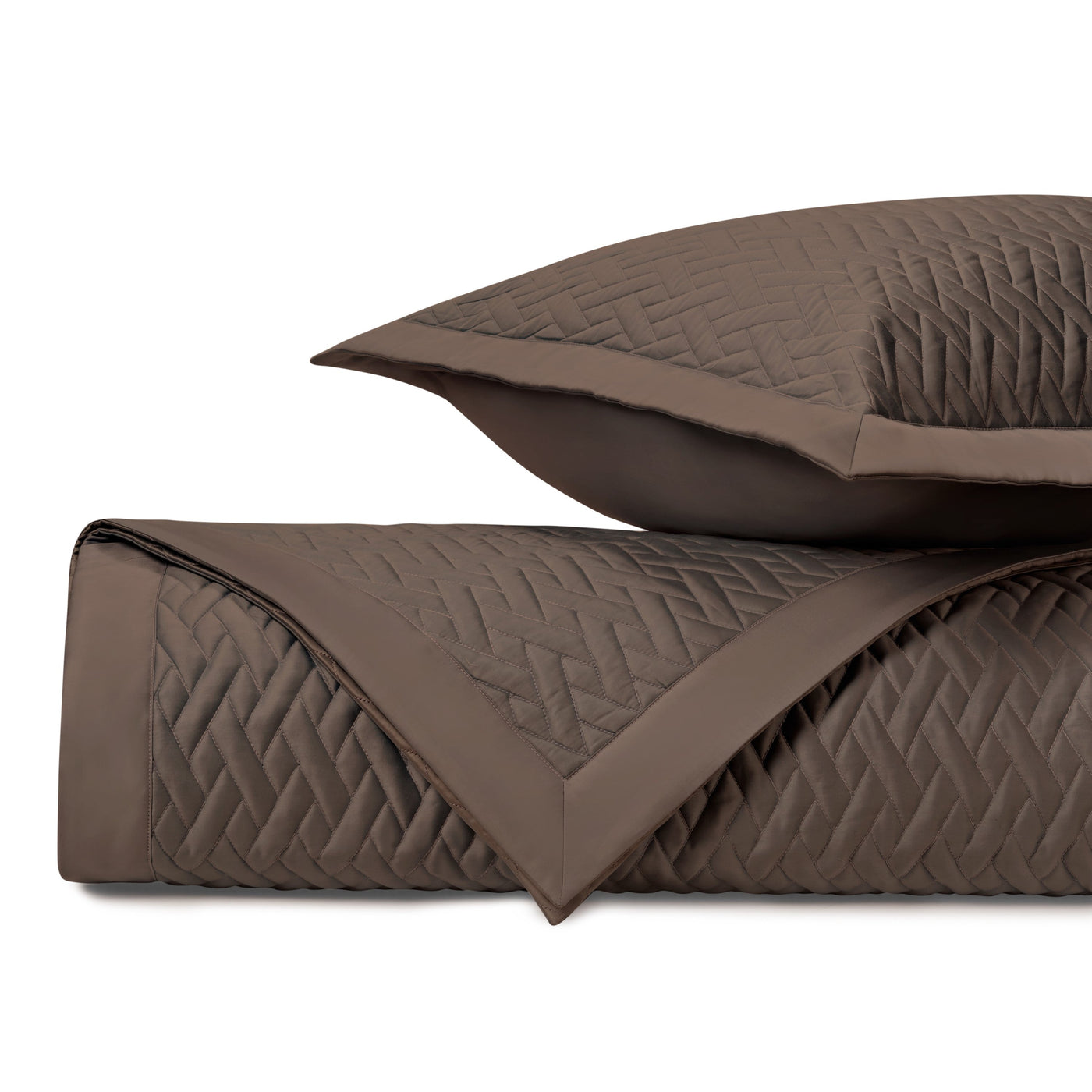 Close-up of Viscaya quilted coverlet in mink, showing diamond stitch pattern and folded edge.