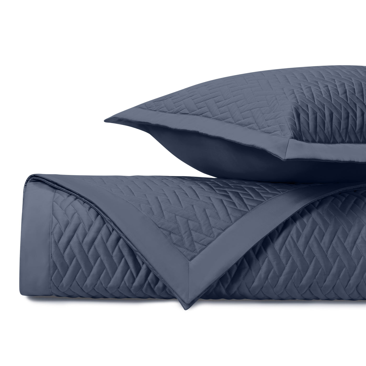 Close-up of navy Viscaya quilted coverlet and sham showing diamond stitch pattern detail.