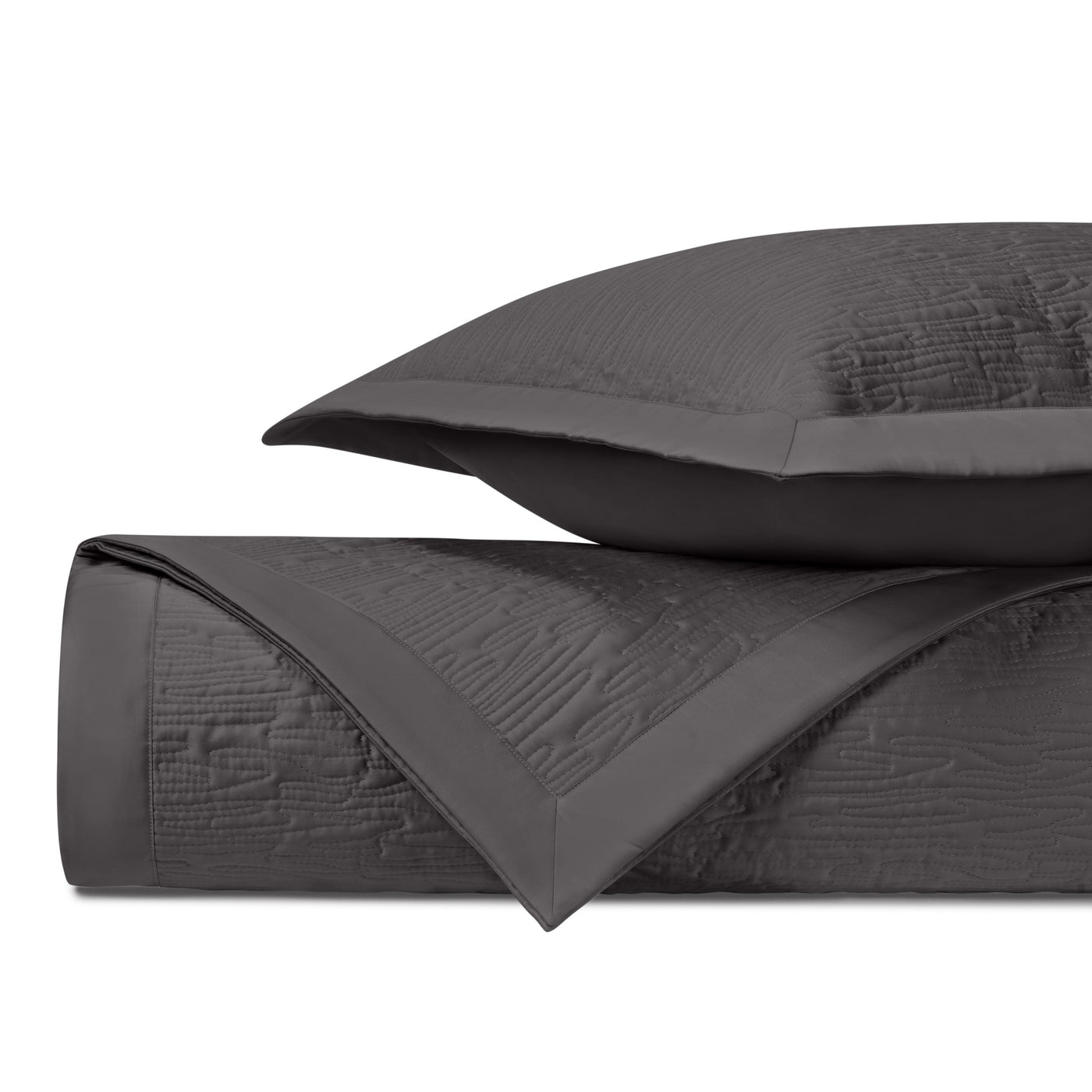 Close-up of charcoal quilted yardage with textured wave pattern and satin border trim.