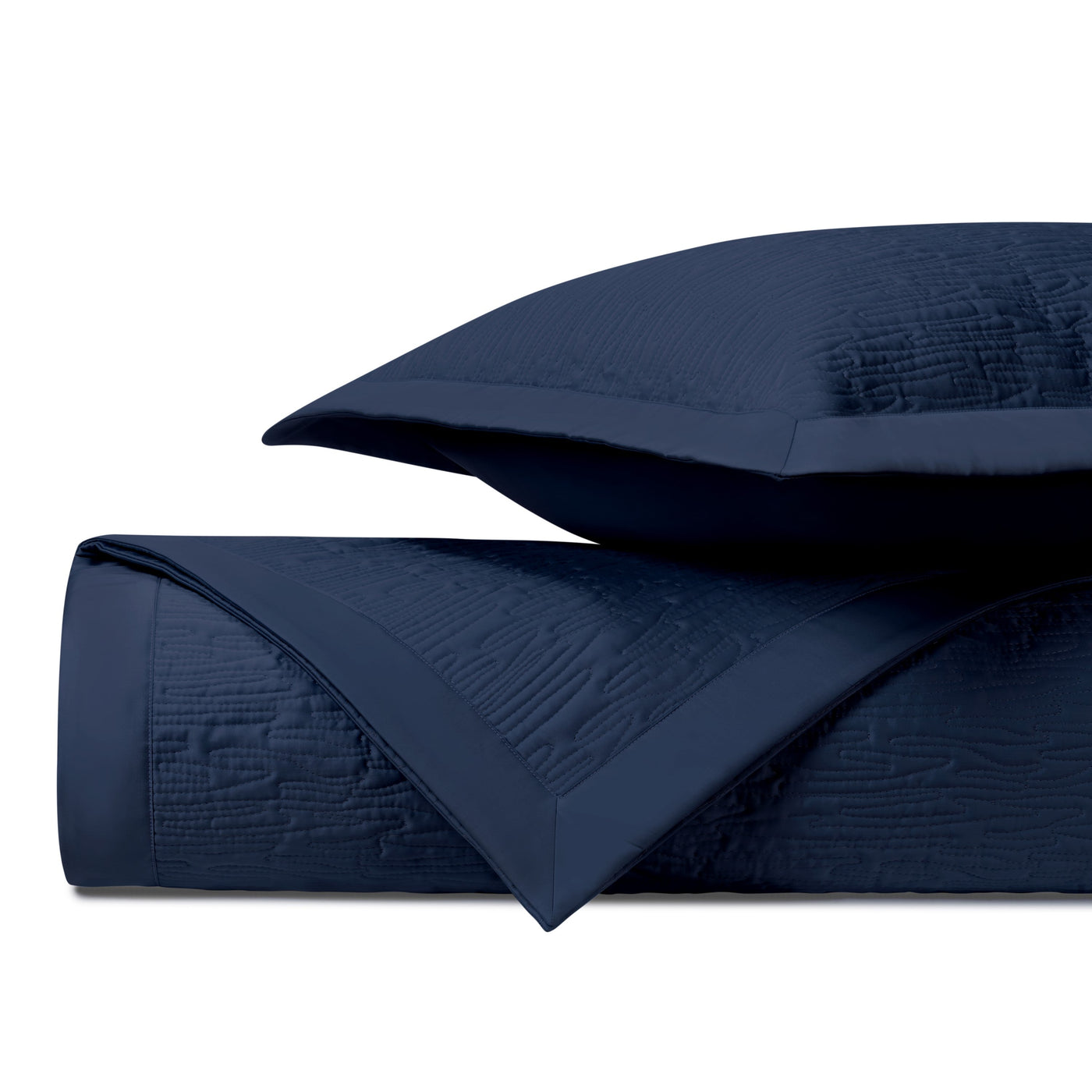 Navy quilted yardage with textured wave pattern and satin border, folded with sham.