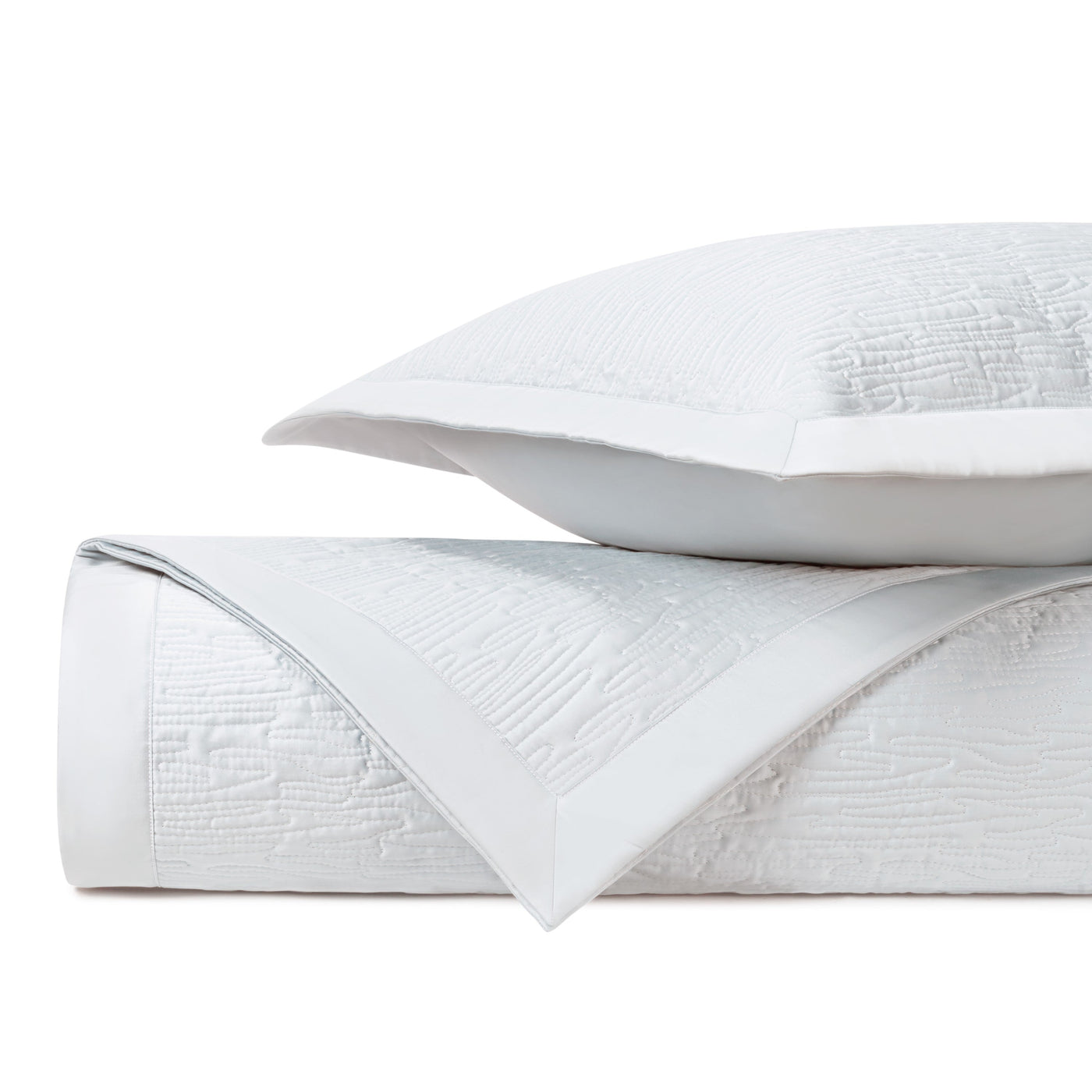 Close-up of Home Treasures Wave quilted fabric in white with textured matelassé weave.