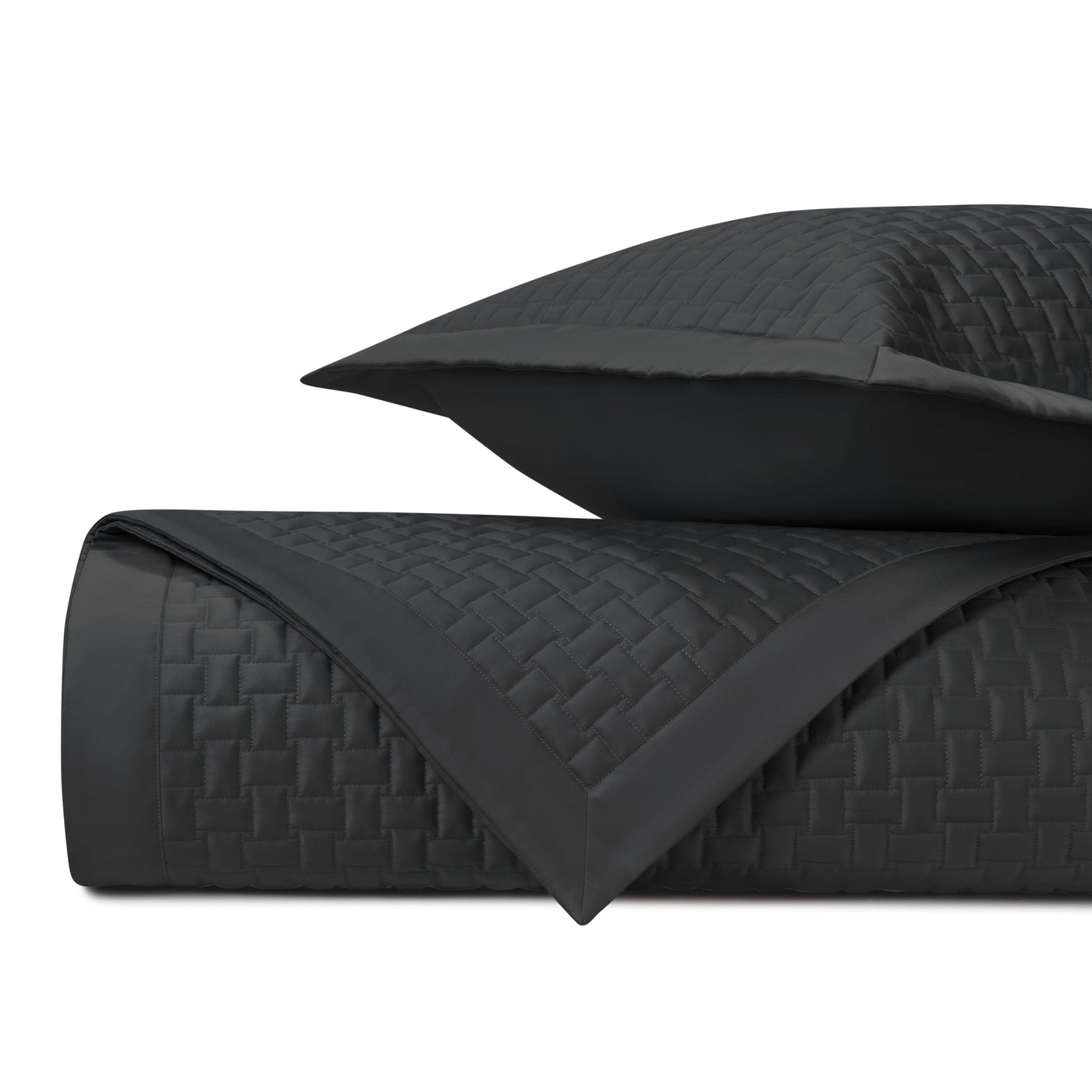 Close-up of Home Treasures Wicker quilted coverlet in black with basket-weave stitching.