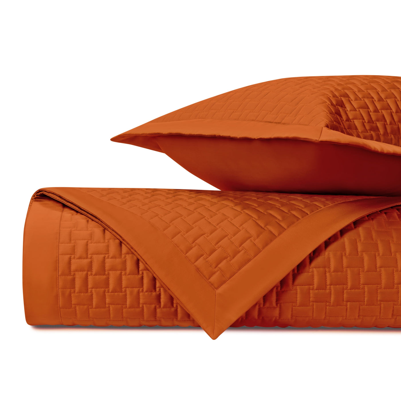 Wicker quilted coverlet and sham in clementine, showing basket-weave stitching detail.