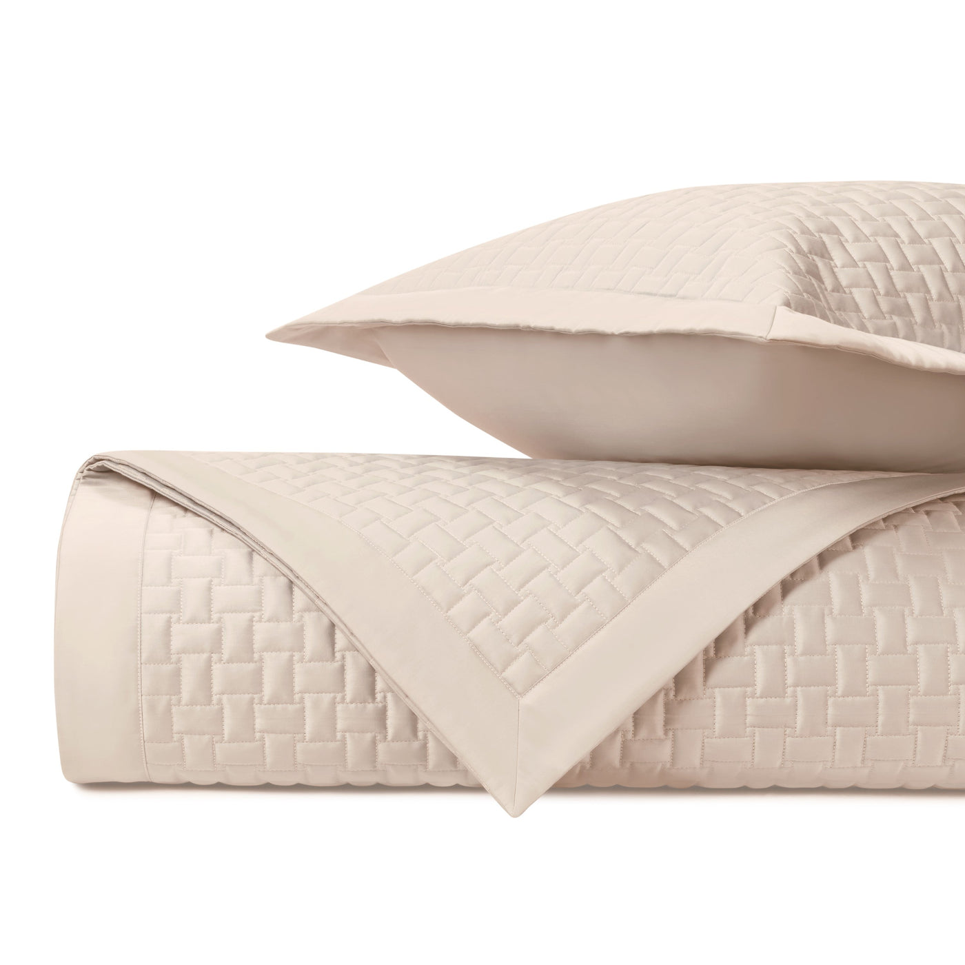Basketweave quilted texture detail on ivory coverlet with coordinating sham.