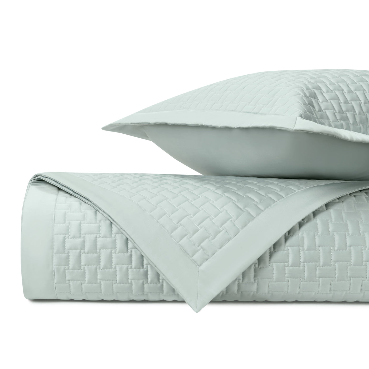 Basket-weave quilted coverlet and sham in mist, folded to show texture detail.
