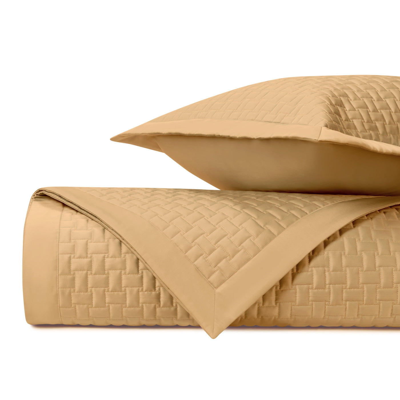 Basket-weave quilted texture detail on honey gold coverlet and sham set.