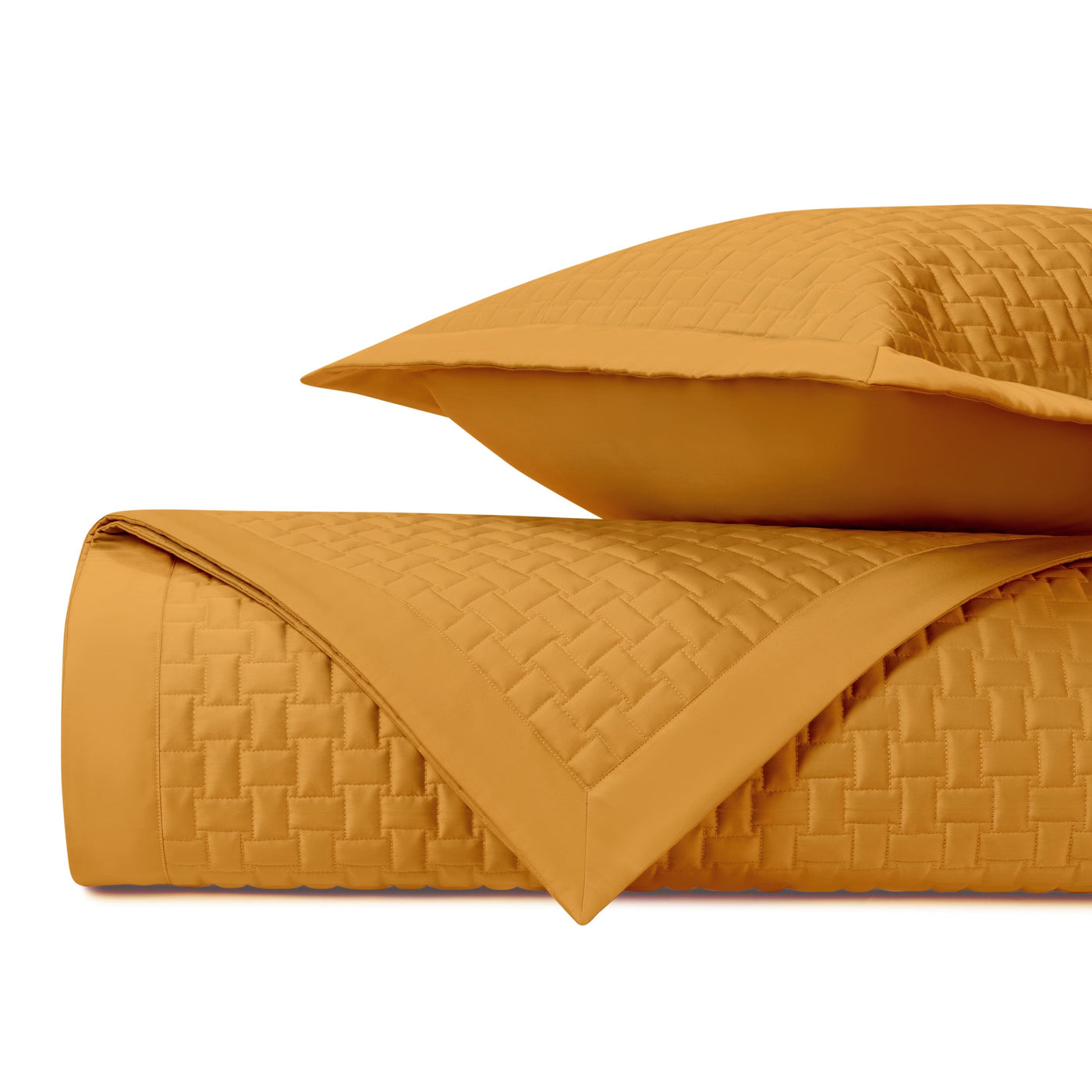 Basketweave quilted texture detail on folded marigold coverlet and sham.